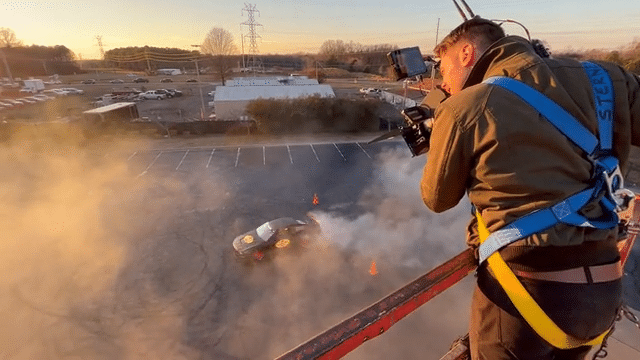 Michael Gauthier films NASCAR legend Joey Logano for a pennzoil commercial while he stands on a high platform at clutch studios in North Carolina 