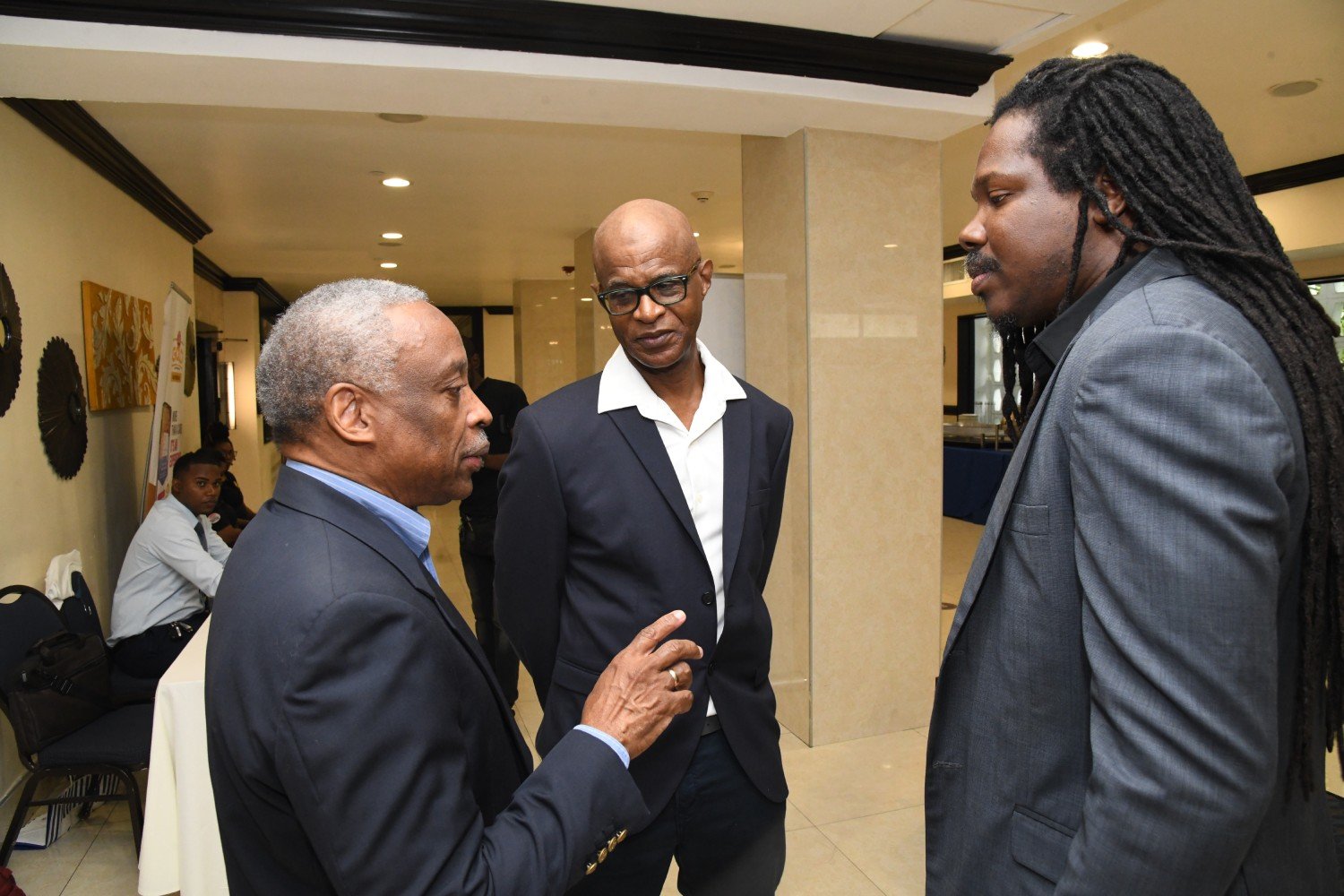 Zed Technologies Directors Milton Samuda and CEO Carlton Grant in discussion with Senator Damion Crawford