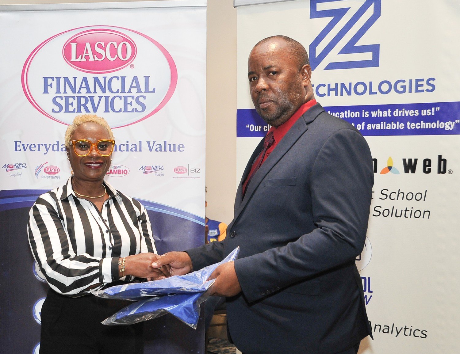 LASCO Financial Managing Director Jacinth Hall-Tracey presenting an award to Leighton Christie Principal of Papine High School