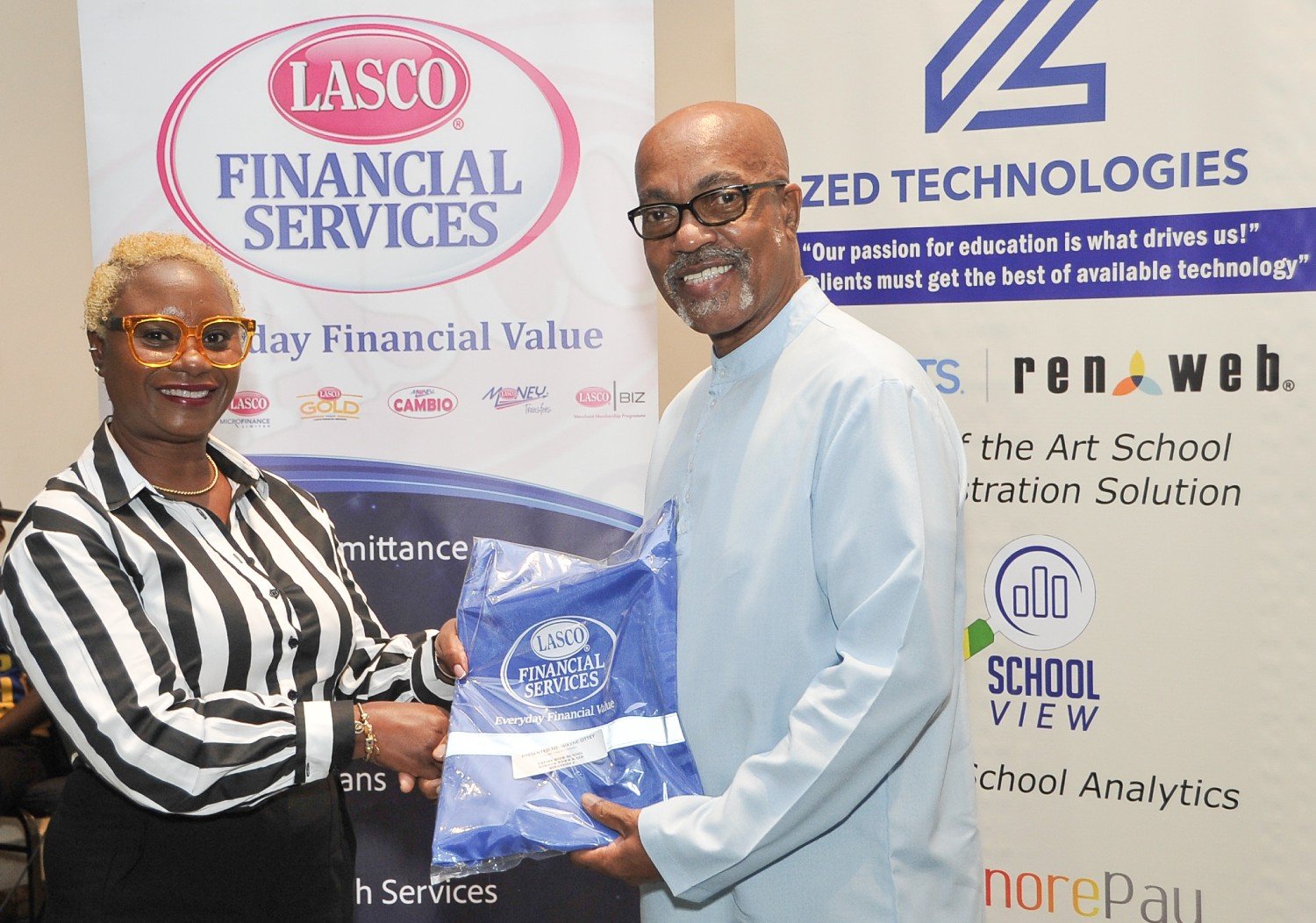 LASCO Financial Managing Directo Jacinth Hall-Tracey presenting an award to Dr. Grantley Sinclair, Registrar and Vice President: Marketing, ICT & Student Services IUC
