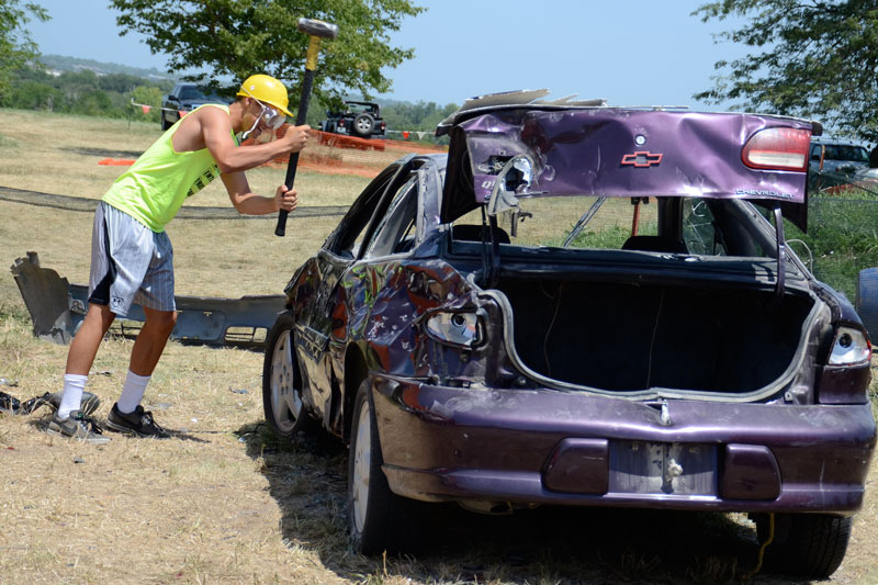 Man smashing purple car