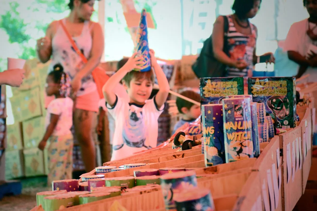 Little boy shopping with family for fireworks