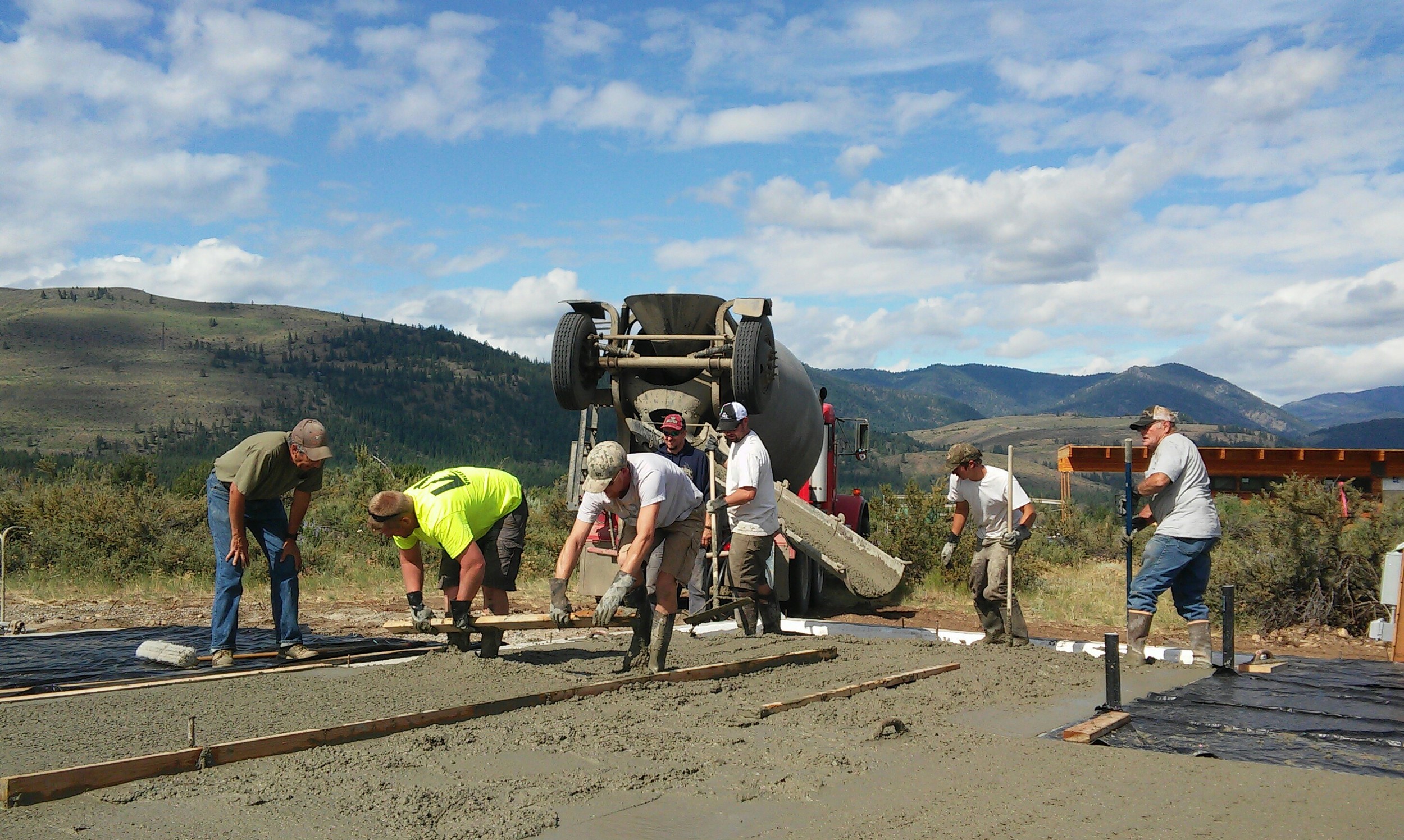 Our slab is being poured. Since this will be our finished flooring, it's important that it comes out smooth, and our concrete crew did a great job. Alex and I will be applying an acid-stain finish on 4th of July weekend, before framing begins.