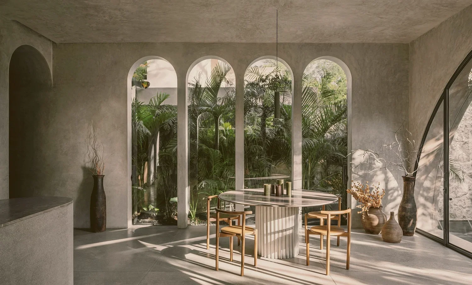 Villa Petricor Tulum — dining room, bespoke marble table with fluted leg, four arched windows with jungle view, CO-LAB