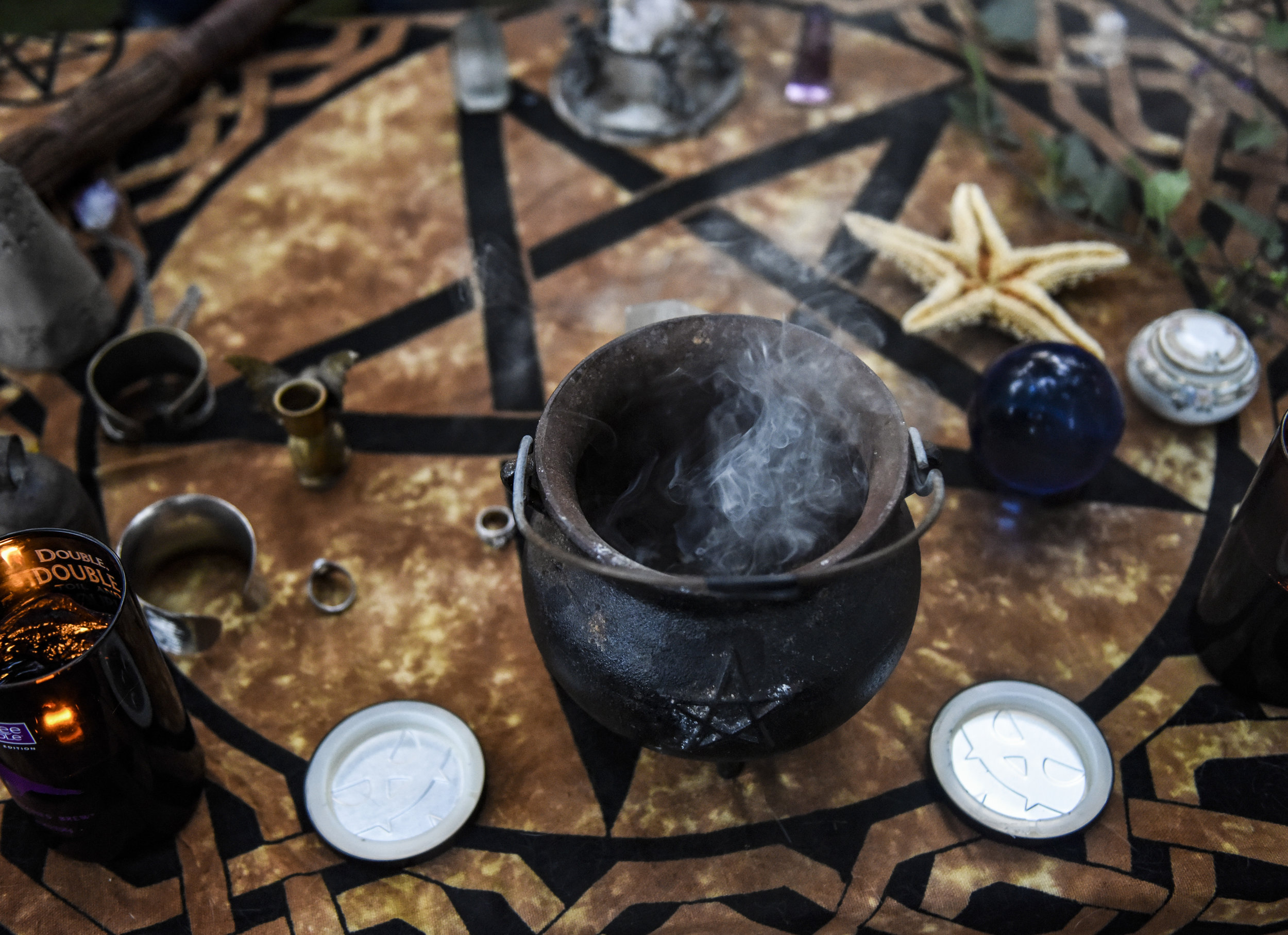  Local witch Jessica's cauldron rest on a table while it burns sage and other herbs while Crafting witches meaningful items are placed on the table to be cleansed, Friday, Aug. 17, 2018. This was before the cleansing of a home to heal a close friend 