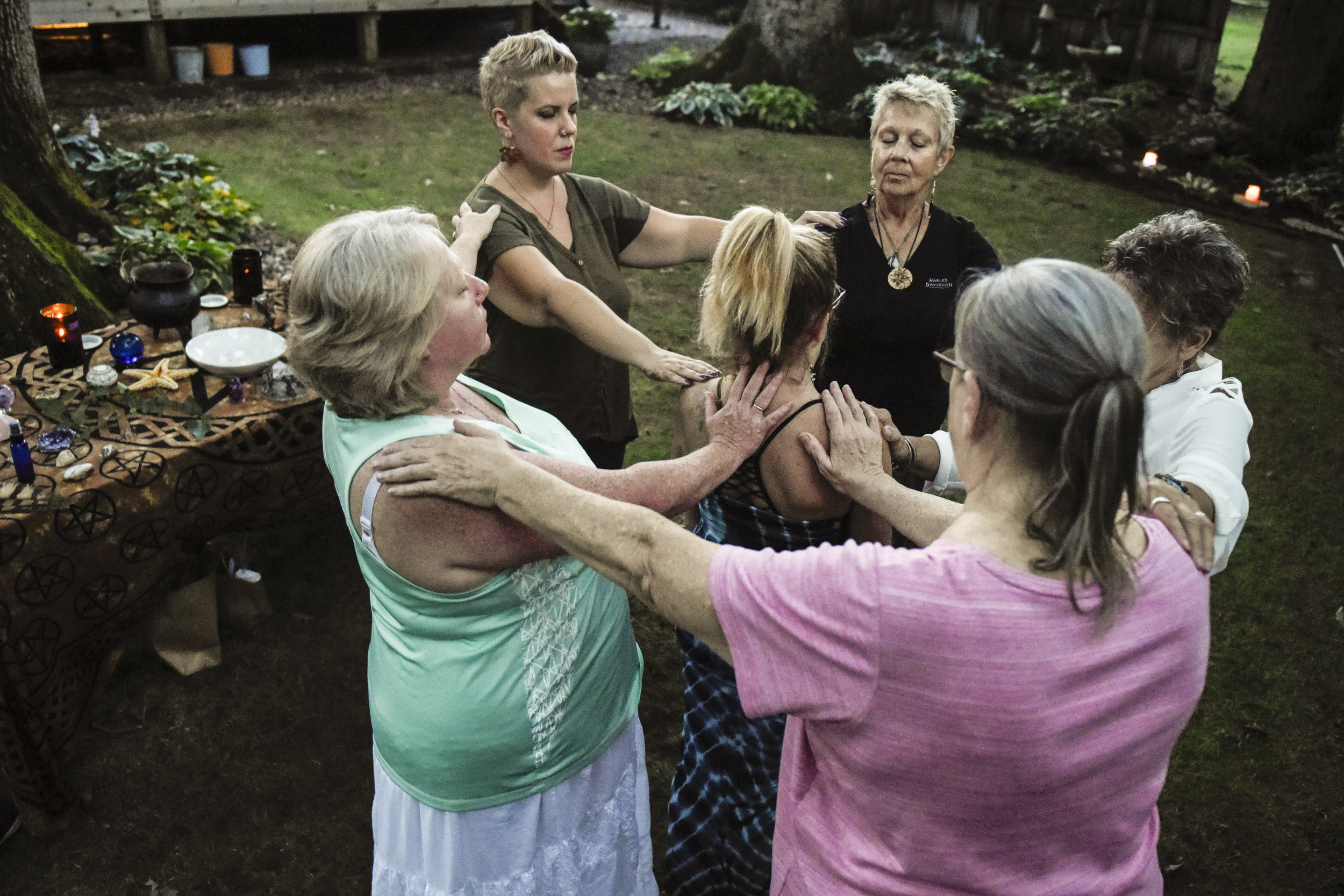  Members of the Crafting Witches coven help a friend deal with a traumatic event from her childhood by conducting a cleansing ceremony in the backyard of her East Moline home on Friday, Aug. 17, 2018. The ceremony offers her their love, support and p