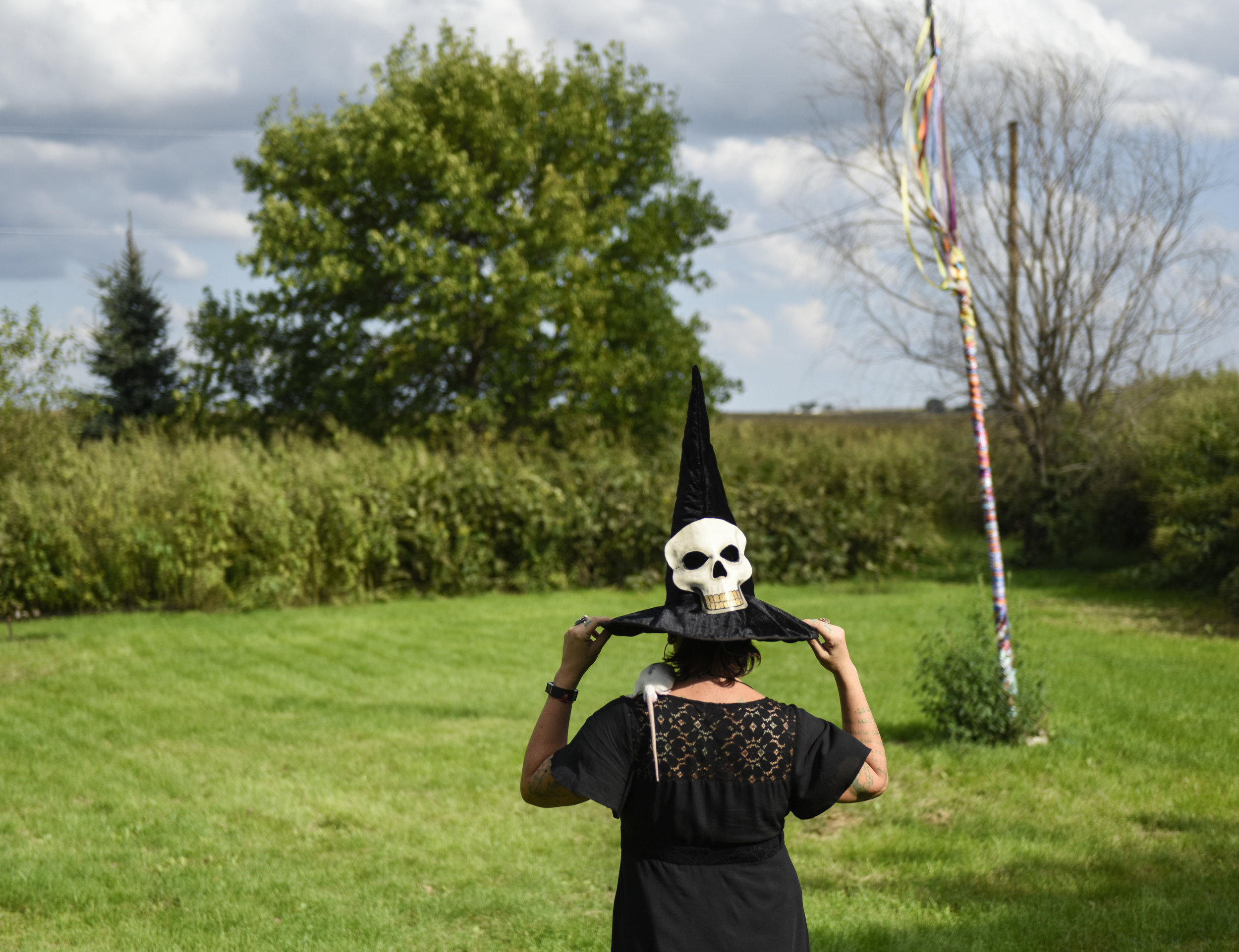  Melanie Hexen stands near her home in rural Iowa on Tuesday, Sept. 4, 2018, with her pet rat on her shoulder. She is part of a family that includes three generations of witches.&nbsp; 