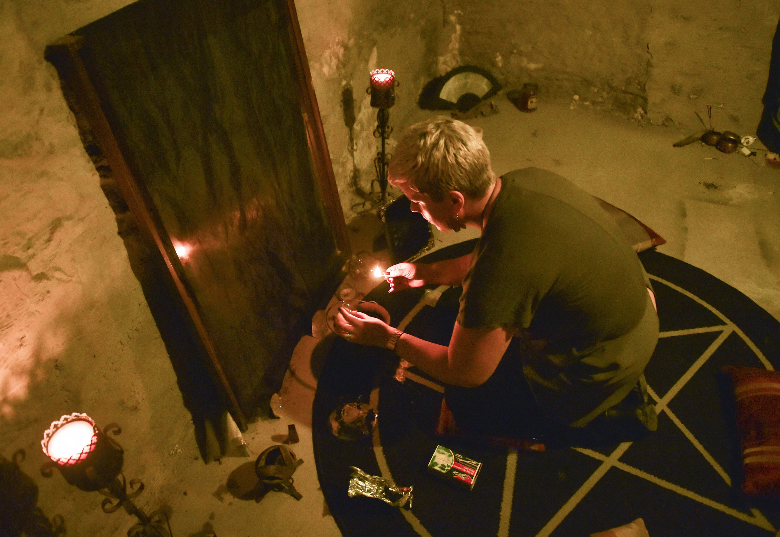  Jessica, of Rock Island, casts a protection spell on Monday, Oct. 8, 2018, in the basement of her home for her group of witches. The spell is cast to protect the group from people who may want to do them harm. 