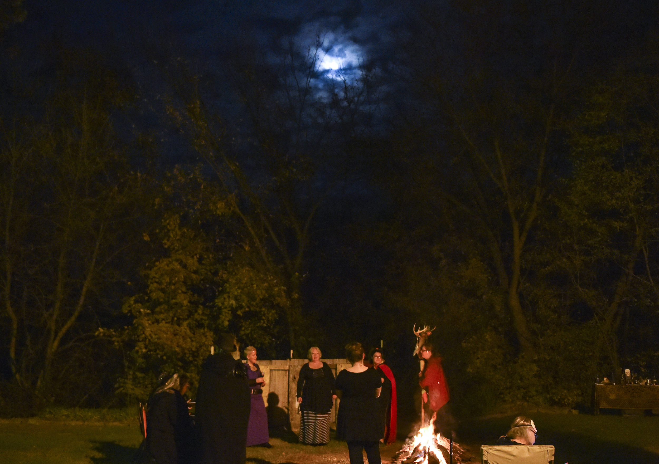  The Crafting Witches coven gather around the fire during Samhain, on Friday, Oct. 26, 2018. It is a ceremony that honors ancestors, friends, witches who have passed and future witches. 