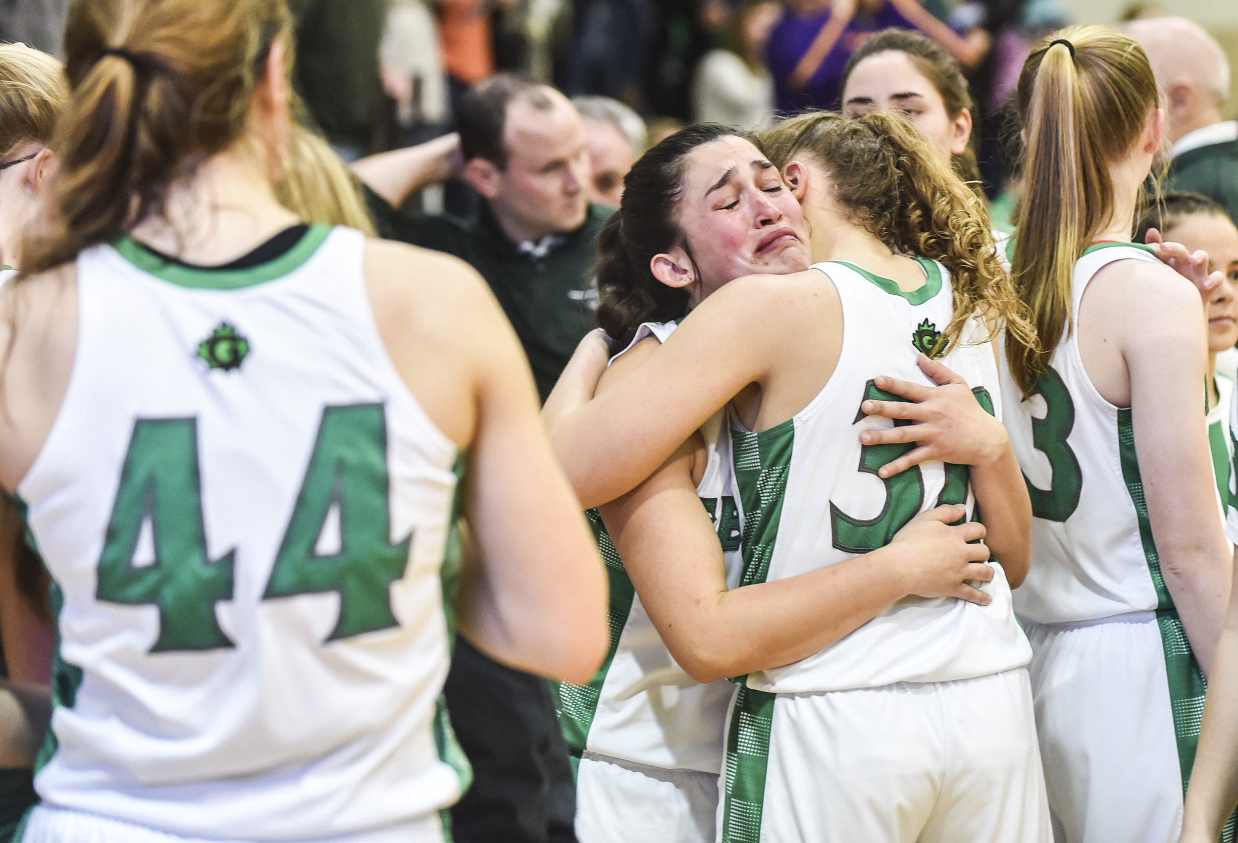  Geneseo’s Kaitlyn Webster (24) is comforted by teammate Kammie Ludwig (30) after the Lady Leafs dropped Friday's Class 3A regional title game to Canton on their home floor. 