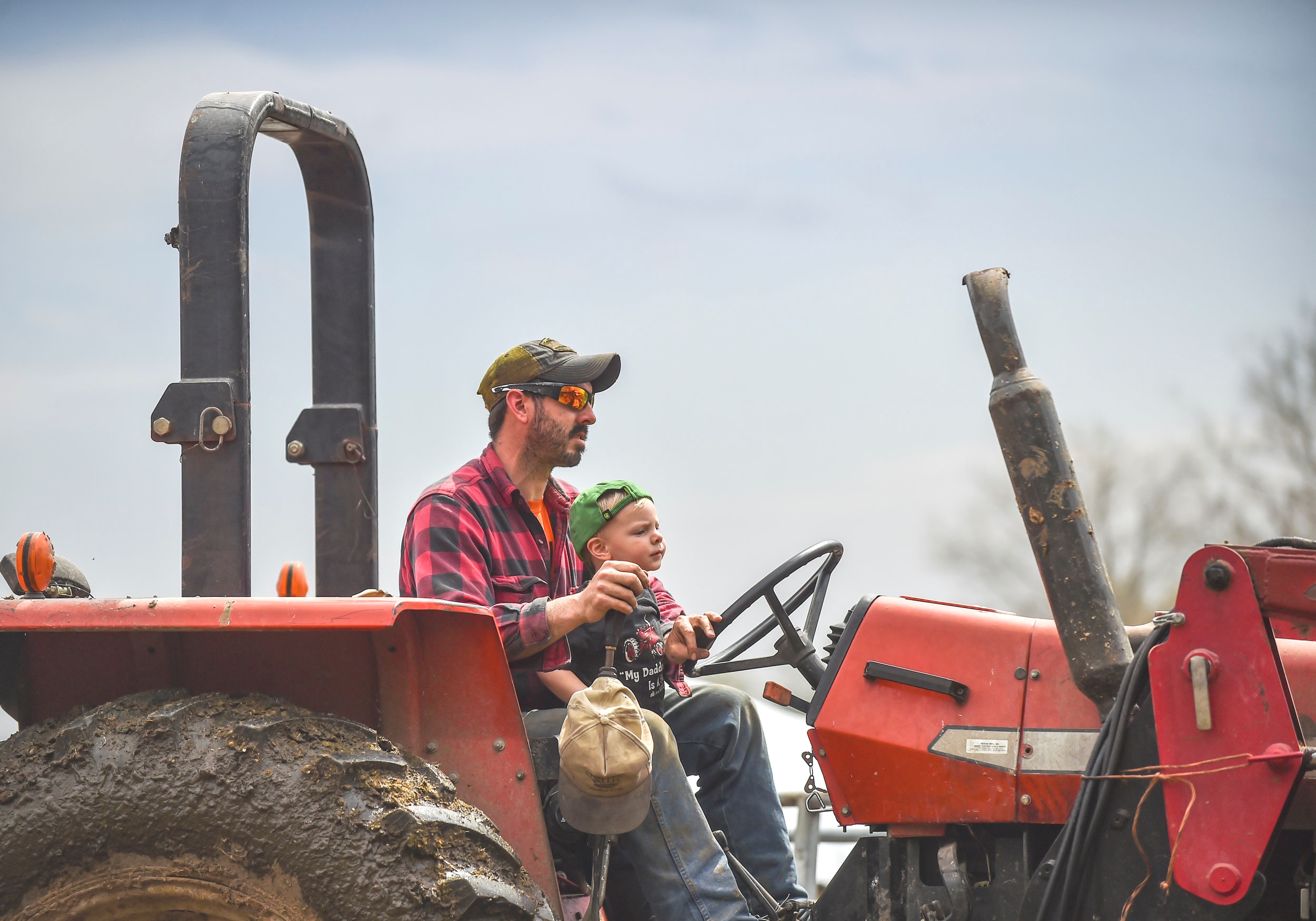  Tom DePauw holds his son, Theo DePauw, in his lap while doing chores at Trinity Acres Monday, April 22, in Port Byron. 
