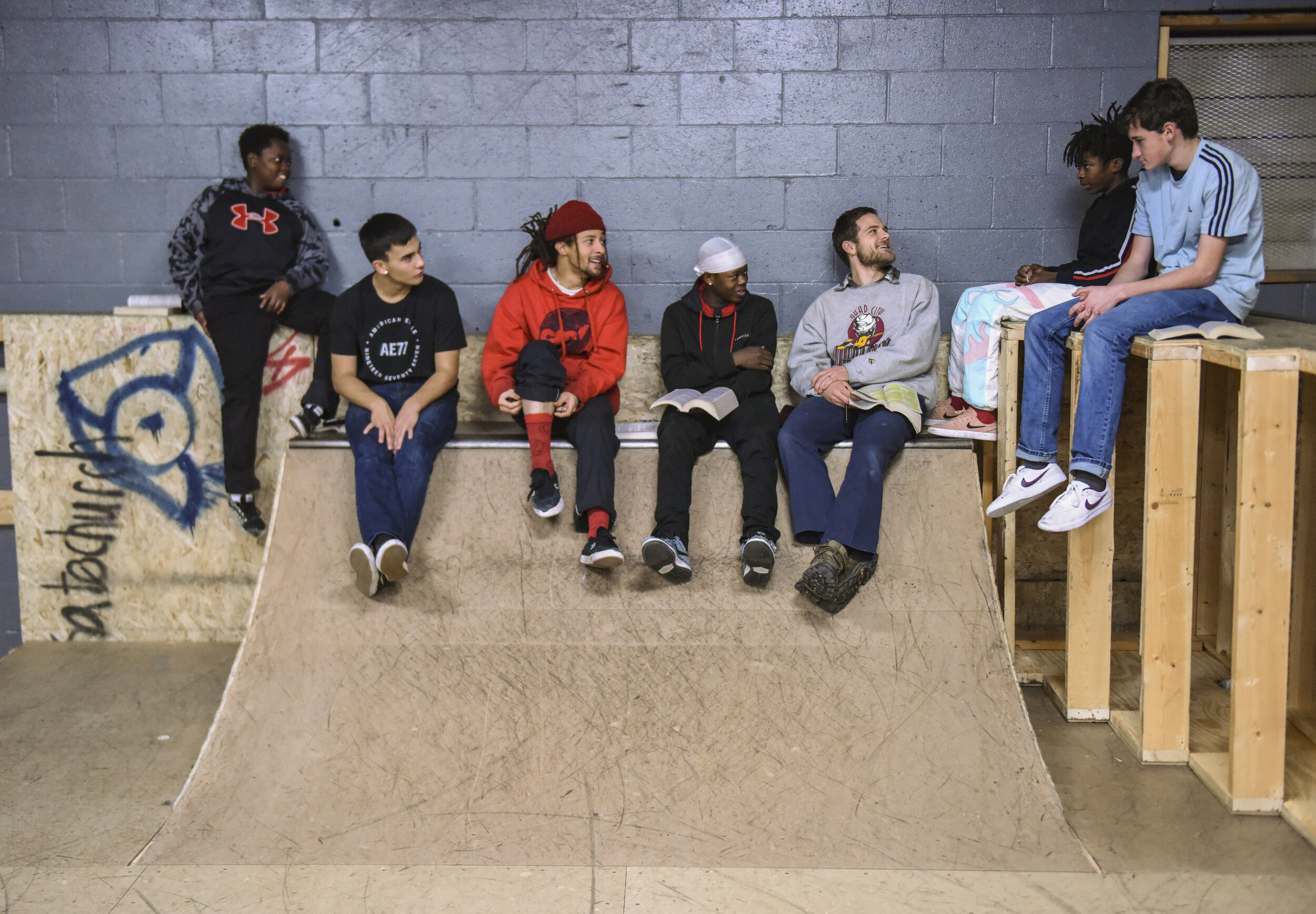  Connor LaBorde, third from right, skate pastor at The Center, leads a Bible study about peace with a group of young men who frequently attend Skate Church Dec. 13 in Davenport. 