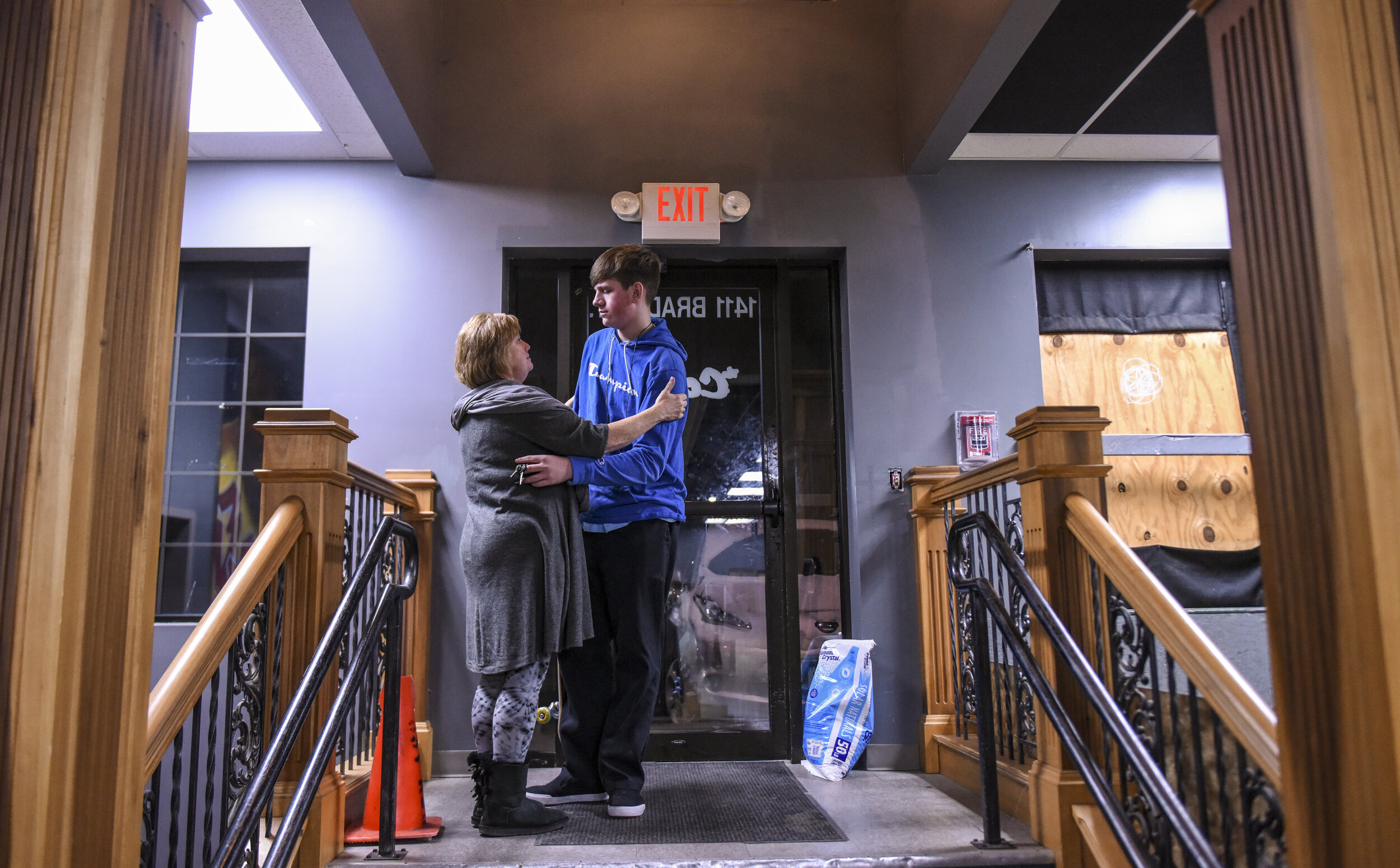  Pennie Kellenberger, director of The Center, and Dylan Nelson embrace Dec. 18 in Davenport after attendees were informed Skate Church would close Jan. 1. Skate Church's future is precarious while its leaders try to sort out insurance issues.  