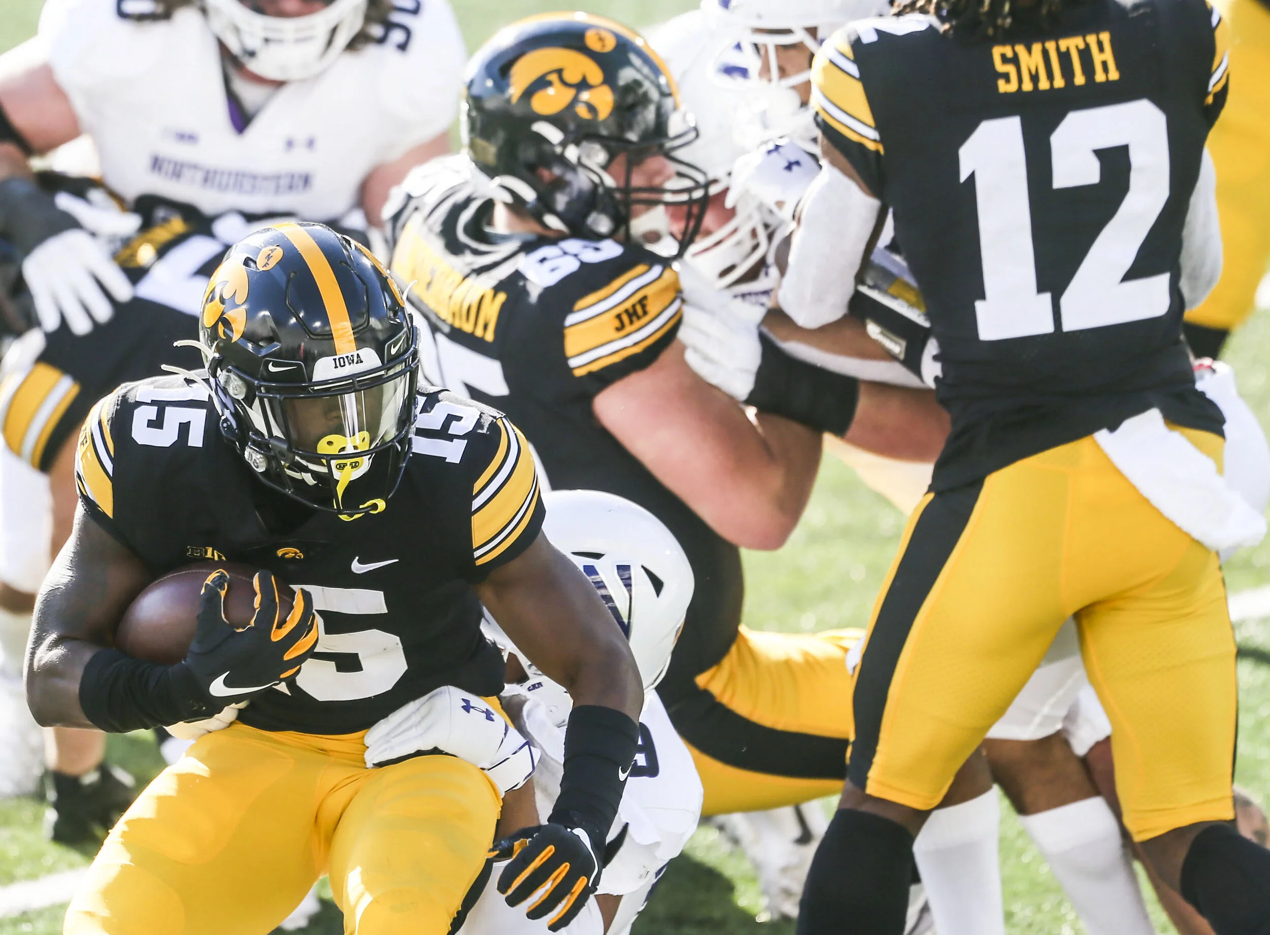  Iowa's running back Tyler Goodson (15) makes it through Northwestern's defense during their game at Kinnick Stadium in Iowa City. 