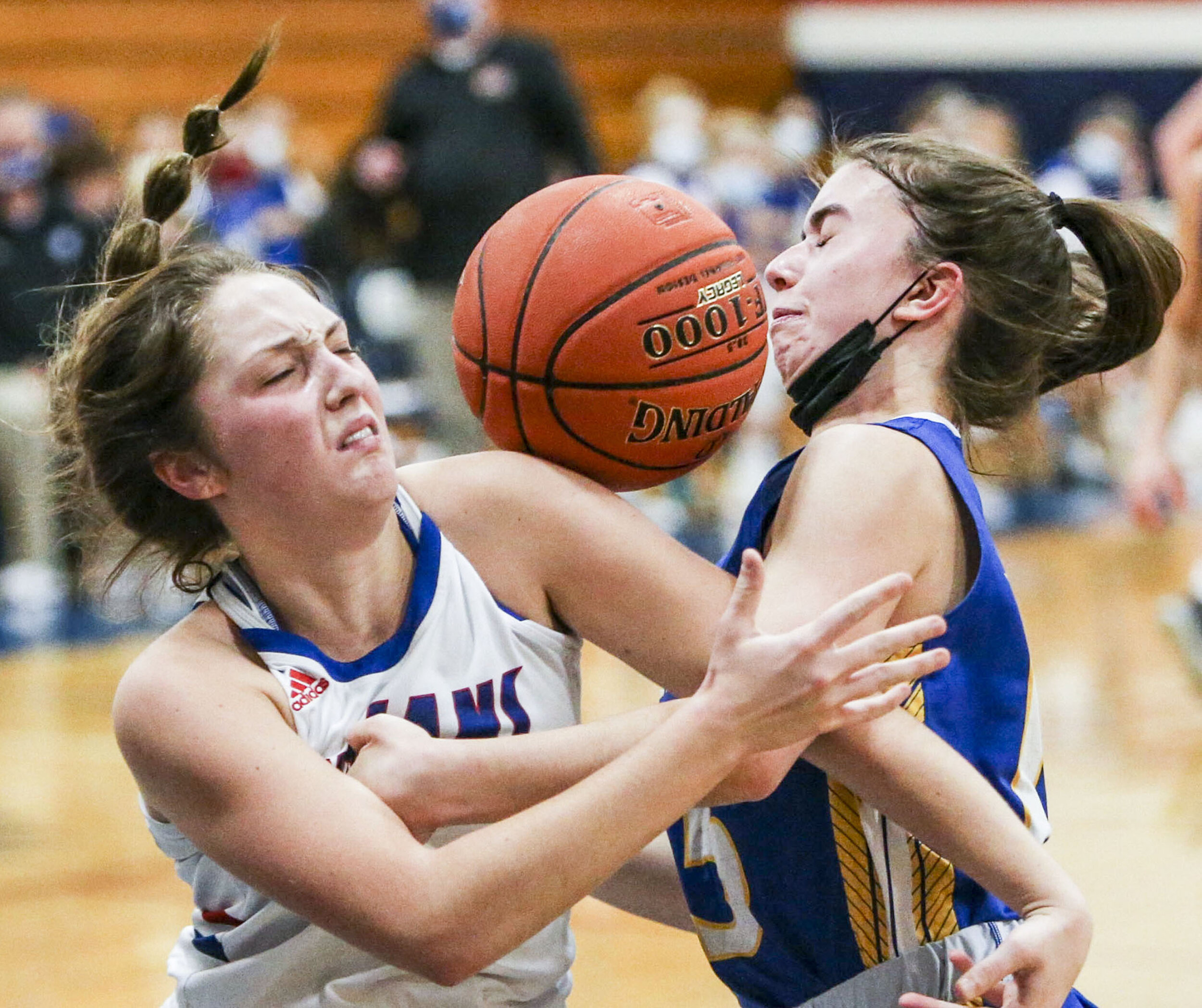  Camanche’s Aubrey Carstensen (4) fights for control of the ball against Wilton’s Mallory Lange (15) at Camanche High School, Tuesday December 1, 2020. 