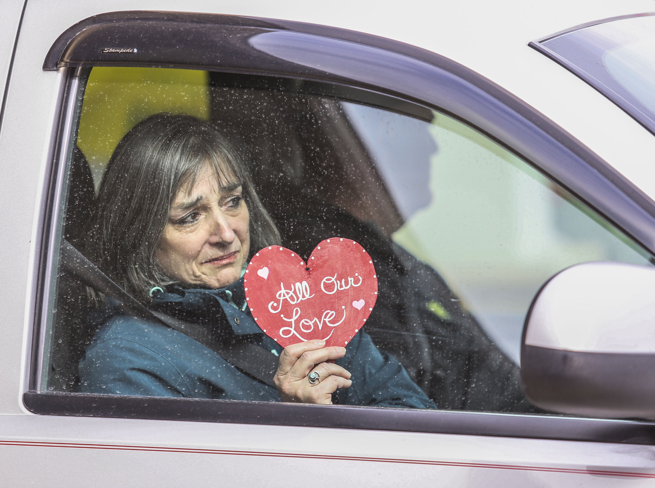  Friends and family go through a drive-thru reception held at Rafferty Funeral Home in Moline for Ben Rogers, a Boy Scout troop leader who passed away from the COVID-19, April 9, 2020.    