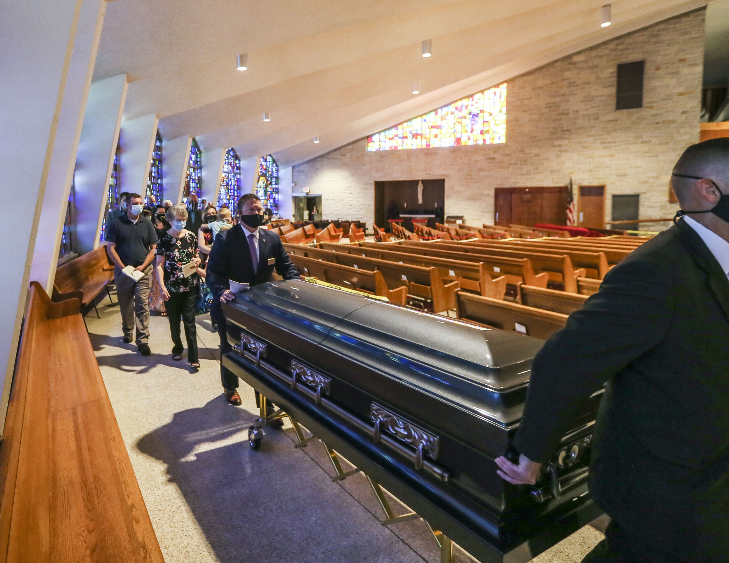  The family of Joseph Burns stand behind his casket while heading to the front of St. Pius X Catholic Church, Rock Island, Sunday, June 15, 2020. The family all wore face masks to protect themselves and those in the church against COVID-19.  