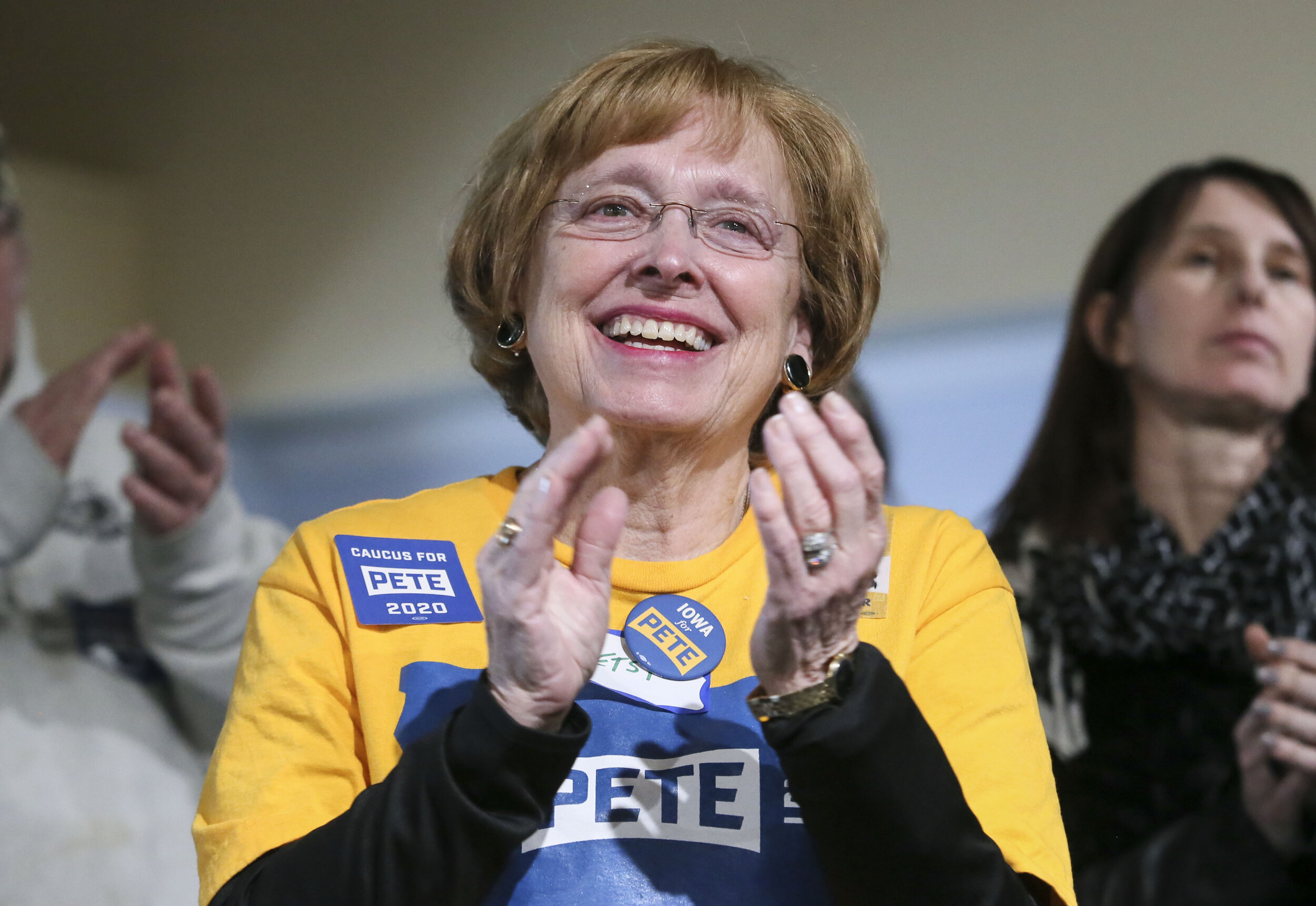  Betsy Fair of Wilton claps for Democratic presidential candidate Pete Buttigieg, and former mayor of South Bend, Indiana as he speaks to supporters in Muscatine at River's Edge Event Loft, Tuesday, Jan. 21, 2020.  