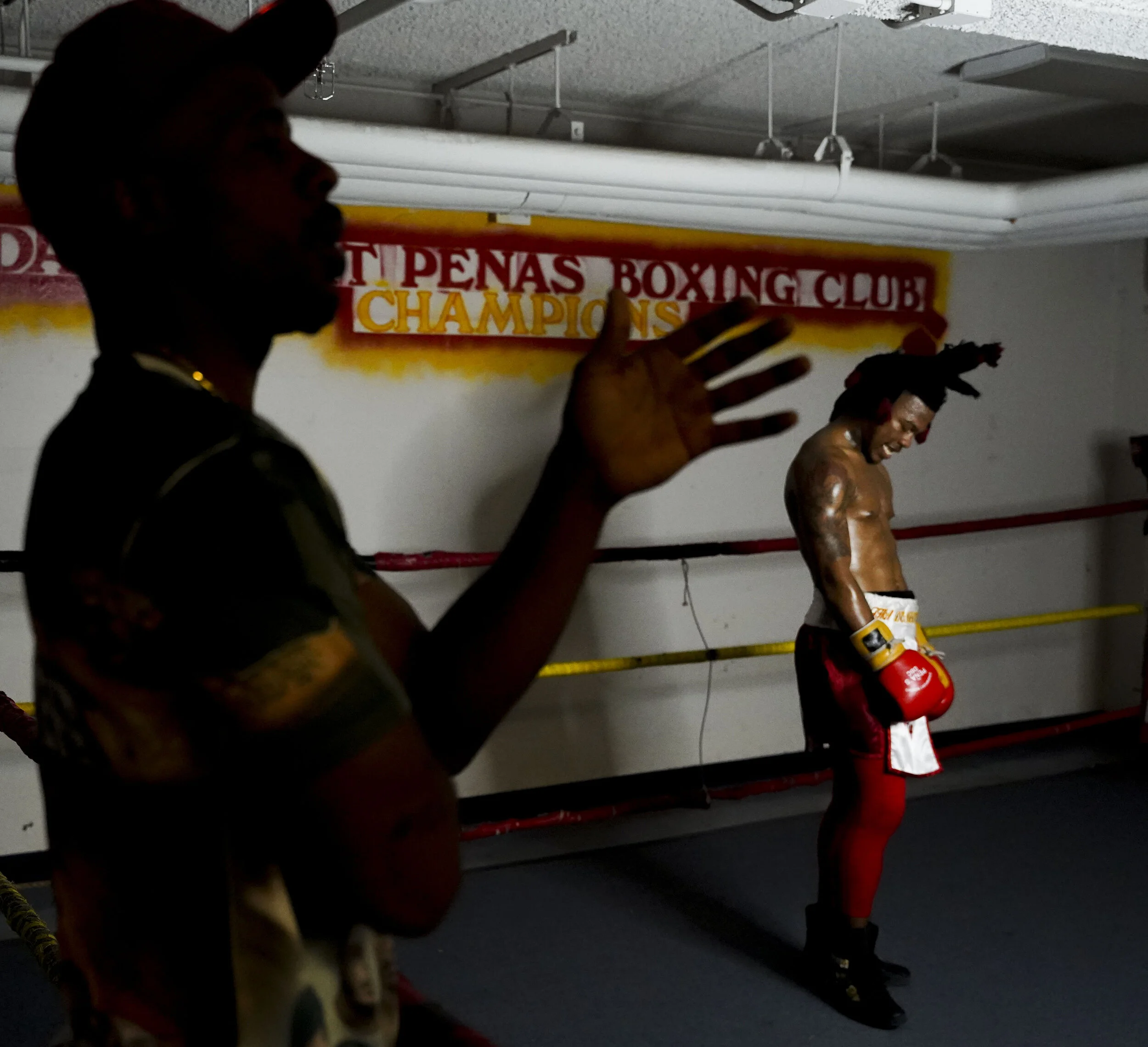  Brandon Bea, manager of Pachino Hill, instructs Hill during a commercial they are shooting for his upcoming fight at Pena's Boxing Club in Davenport. 