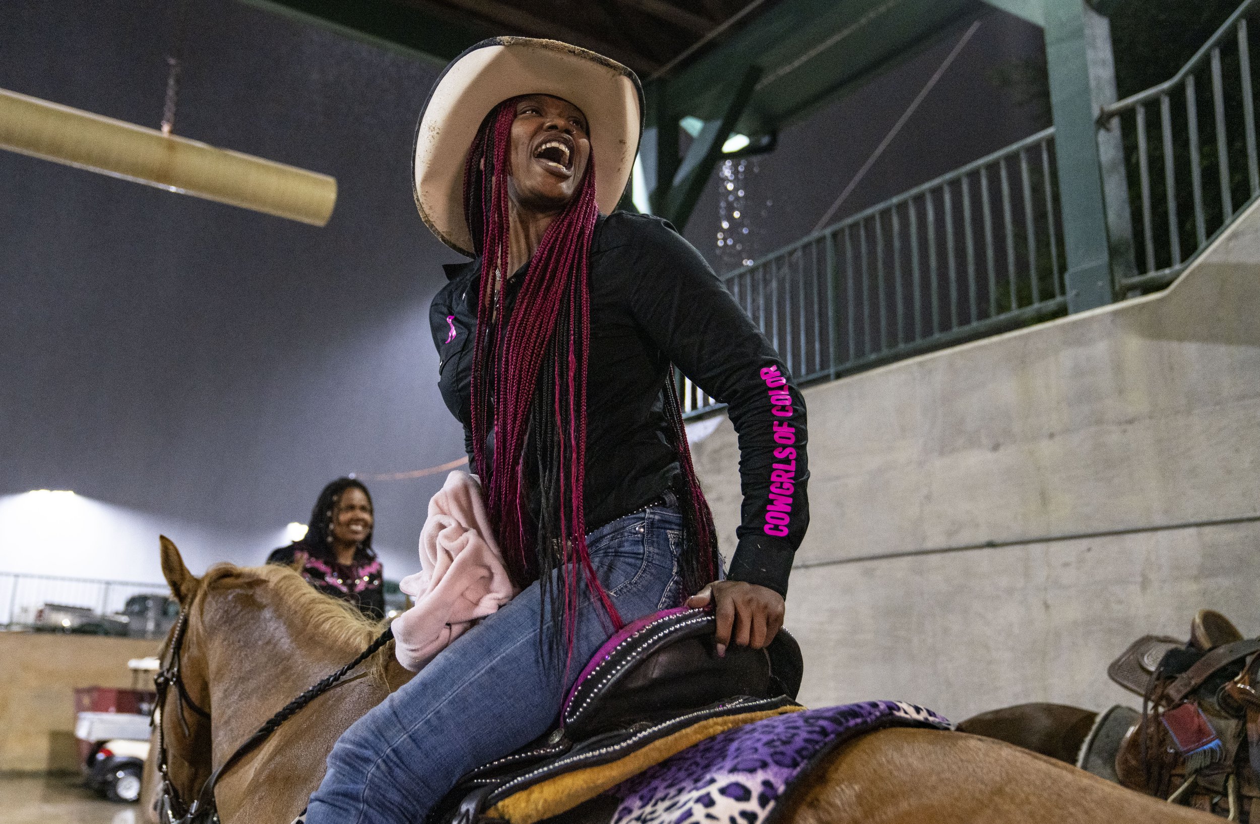  Sandra "Pinky" Dorsey, cheers on other competitors during the Bill Pickett Invitational Rodeo, at the Show Place Arena. 