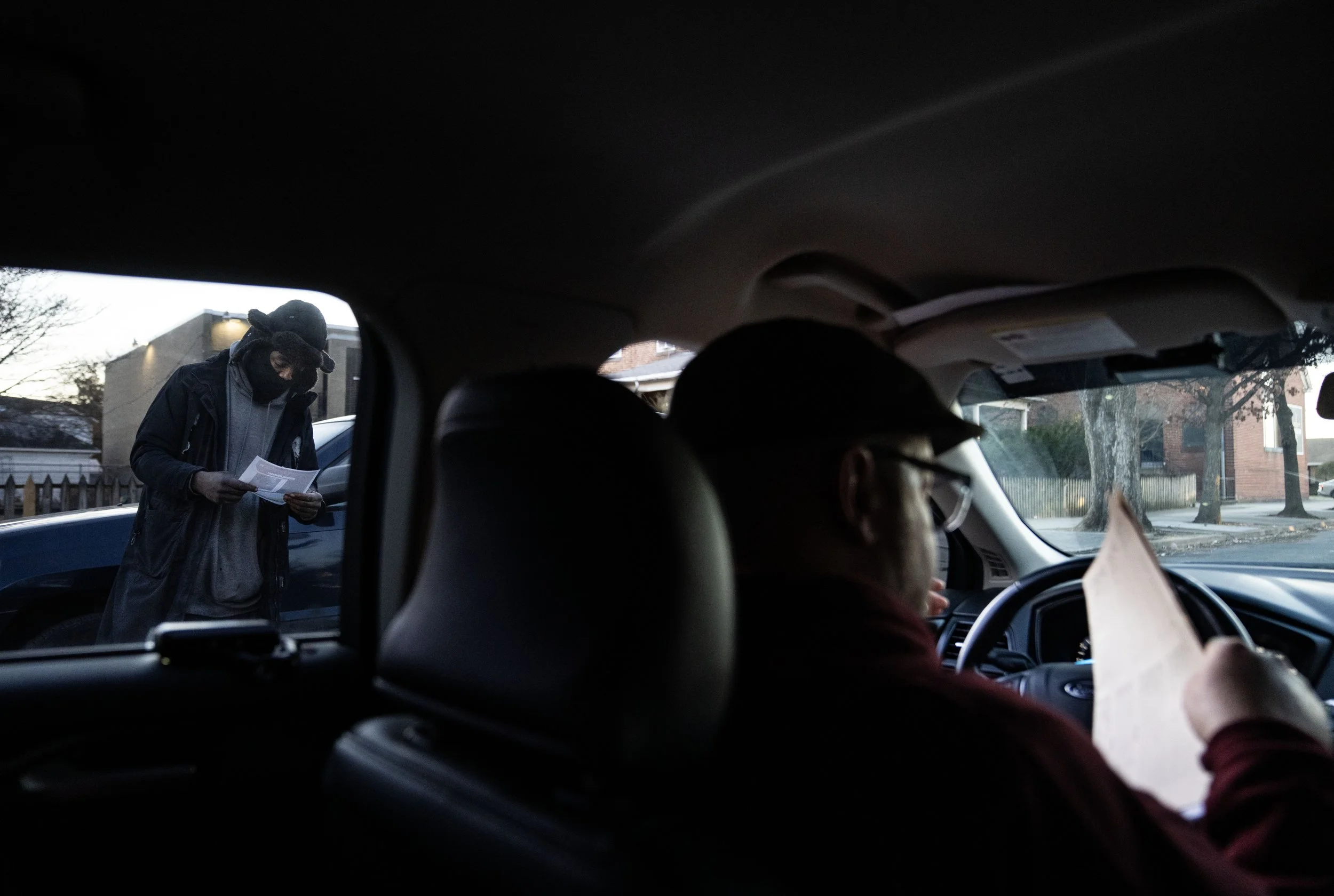  Scott hands out a missing person flyer to a man in the neighborhood, who recognized Tristan from his photo. 