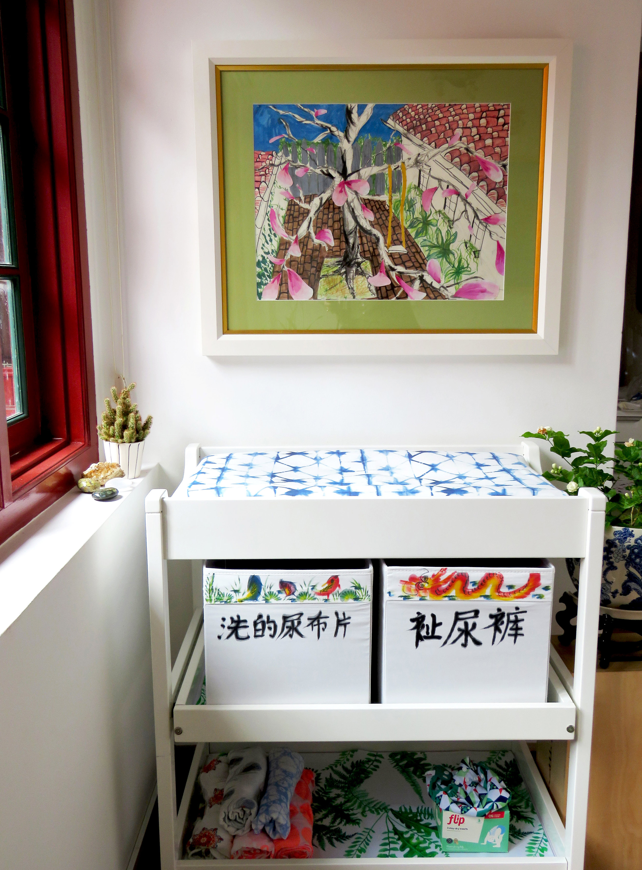 up-cycled changing table, Mandarin calligraphy-labeled boxes for cloth diapers and jasmine plant.