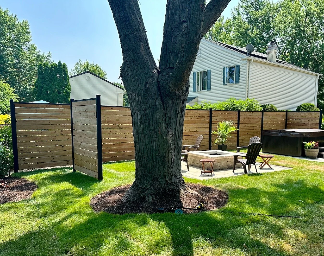 Modern wood privacy fence installed around a residential backyard
