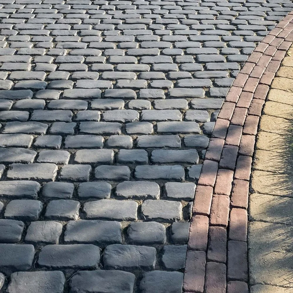 Decorative paver driveway with contrasting brick border