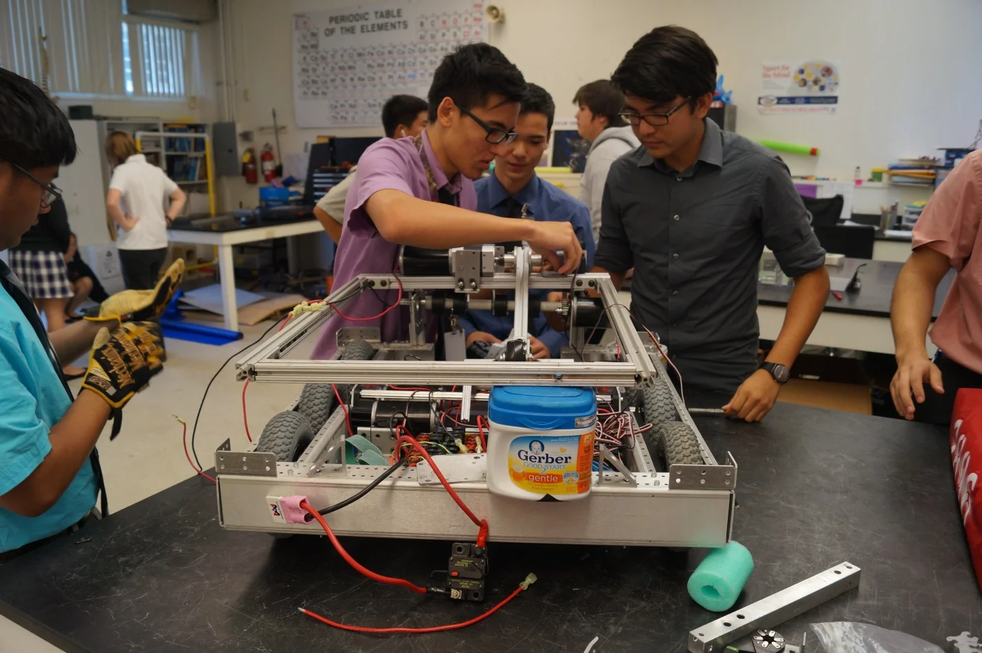 Team 2896 brainstorm a solution while building their robot.