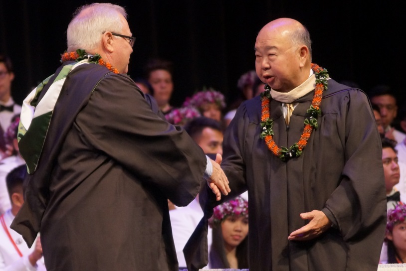 Mr. Ho is congratulated by current Damien Chairman, Board of Directors, Gregory Sitar ‘78