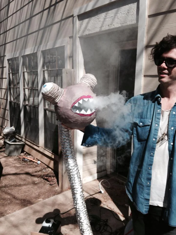 Drummer Zac Cowell holds the infamous snake monster.