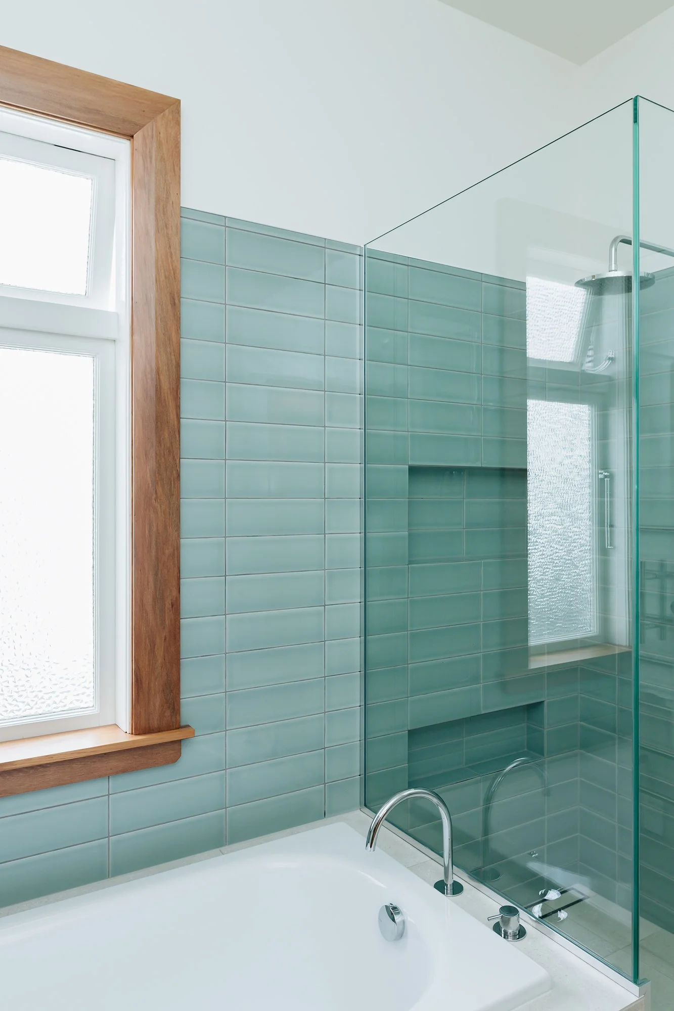 blue-half-wall-tiled-bathroom-wooden-window-frame.jpg