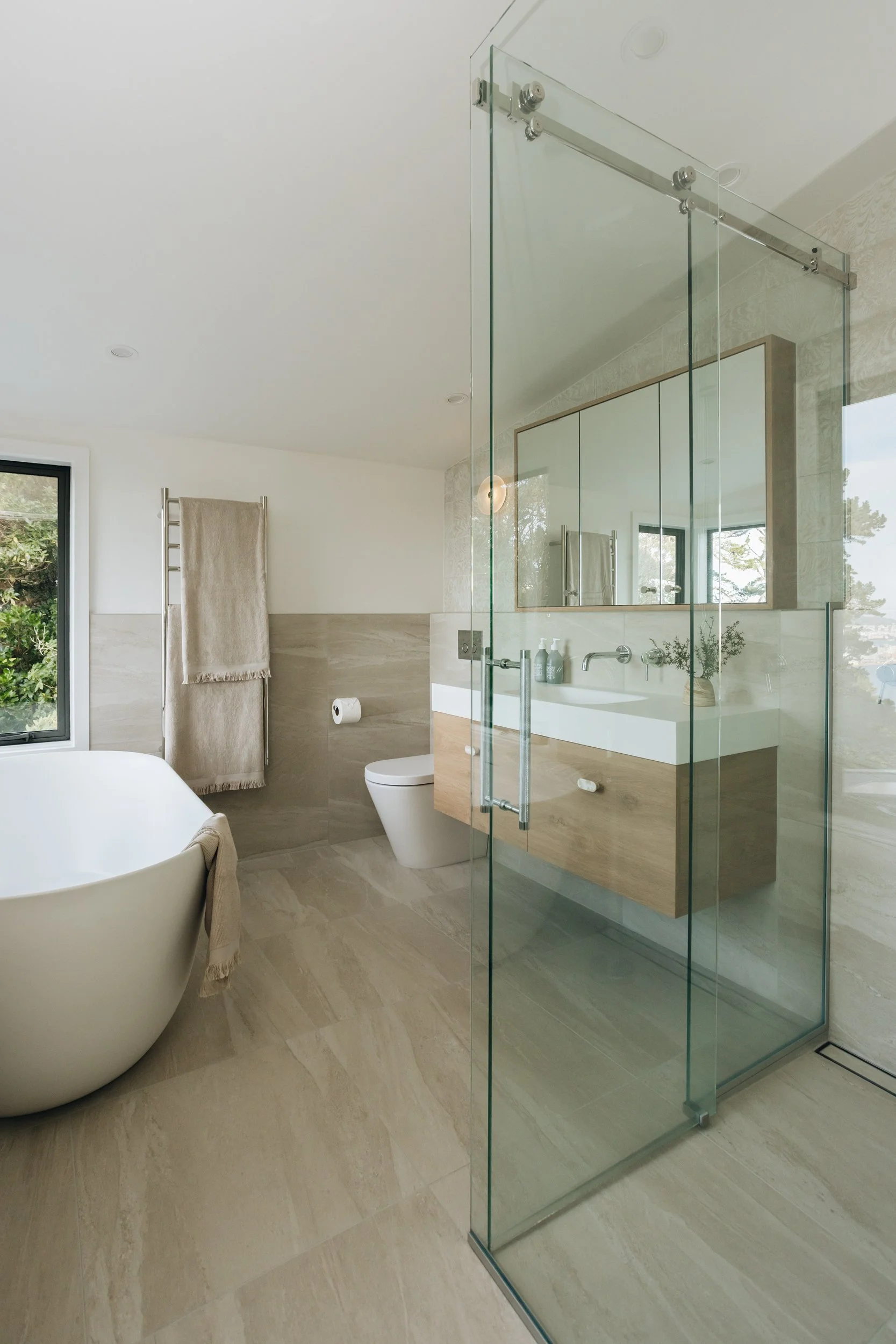 Modern ensuite bathroom with harbour views and freestanding bath – Kerryn Dunshea Interior Design