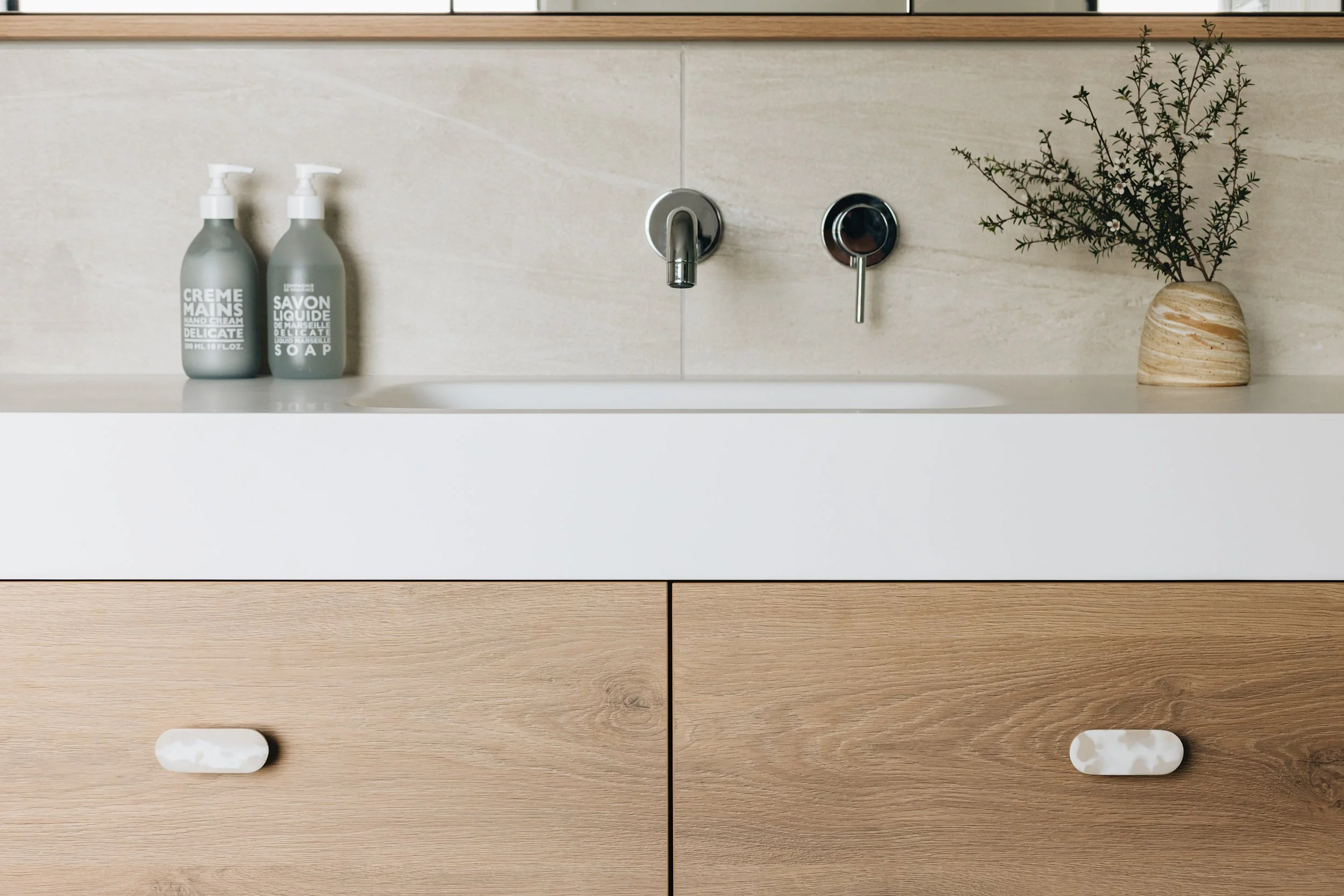  Neutral toned bathroom with Variegati Avorio tiles and timber cabinetry 