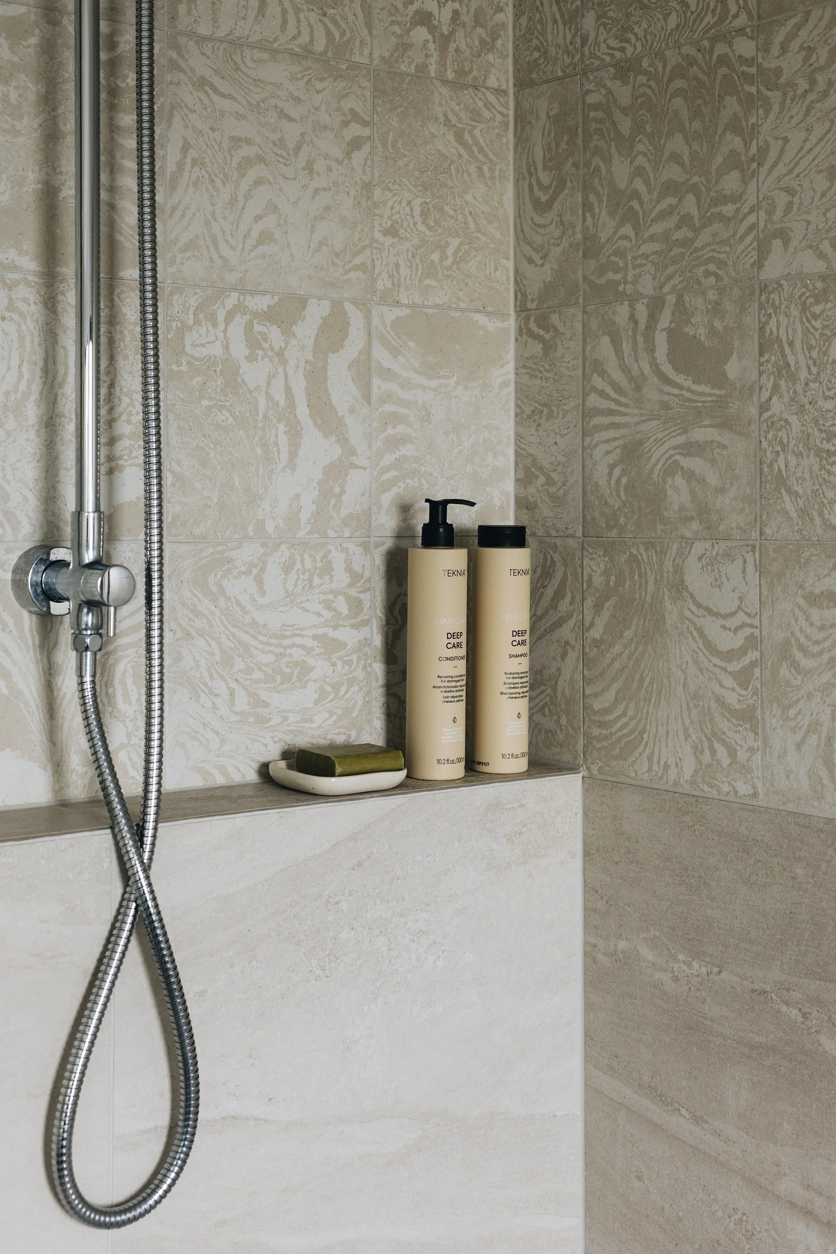  Neutral toned bathroom with Variegati Avorio tiles and frameless shower 