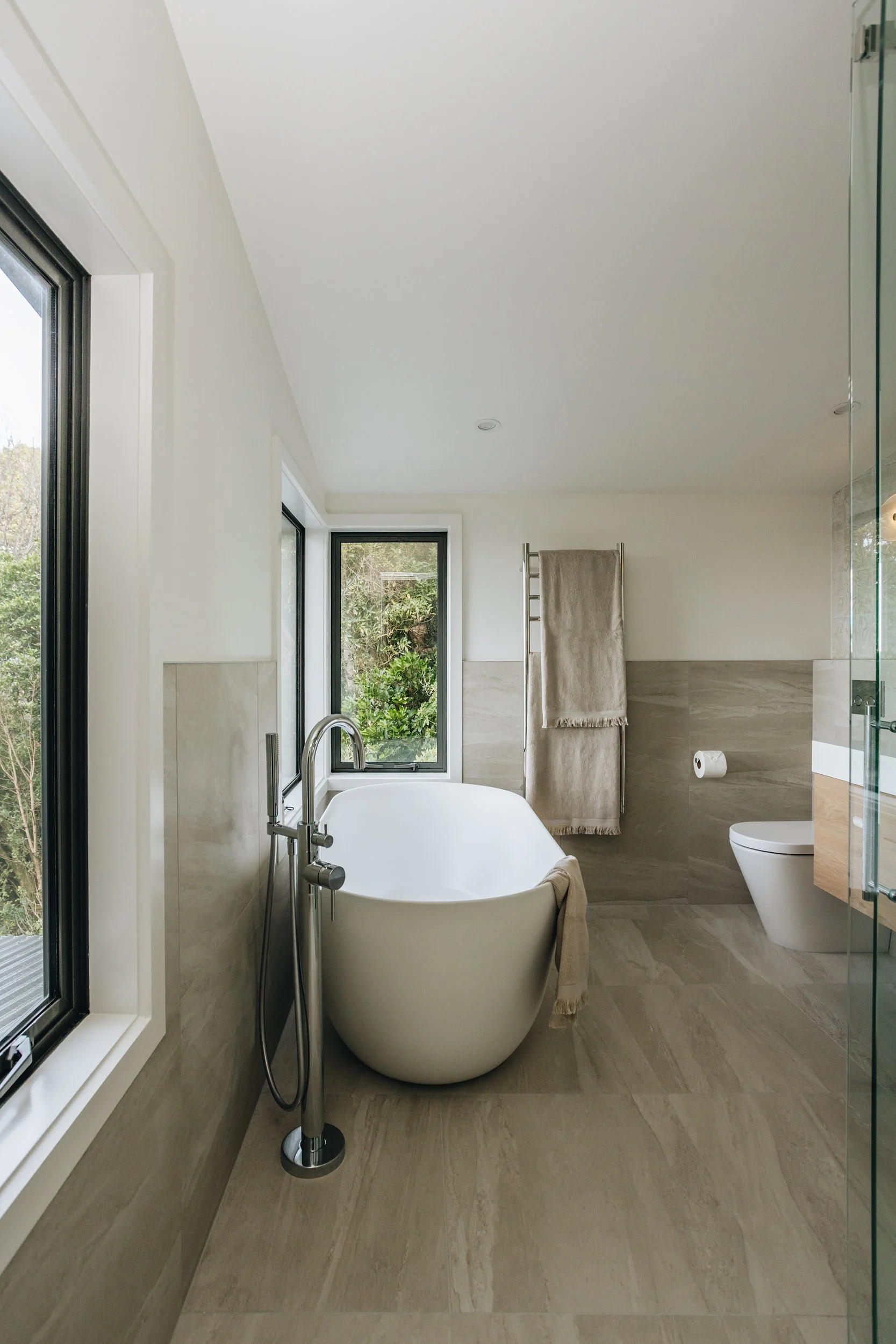 Modern ensuite bathroom with harbour views and freestanding bath – Kerryn Dunshea Interior Design