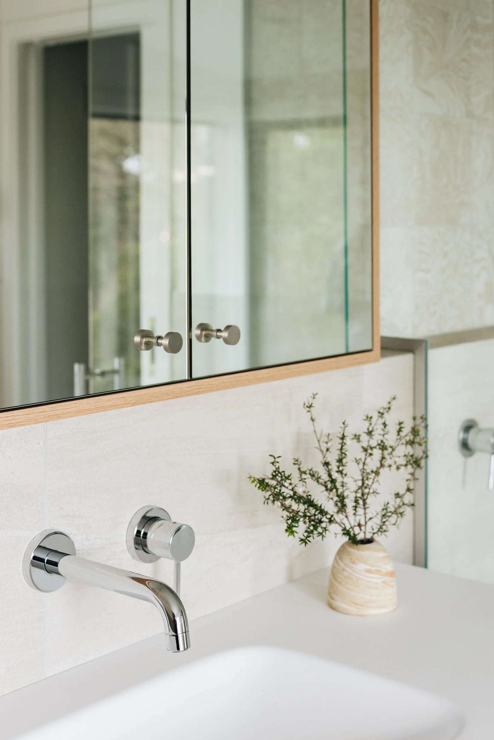  Neutral toned bathroom with Variegati Avorio tiles and custom timber cabinetry 