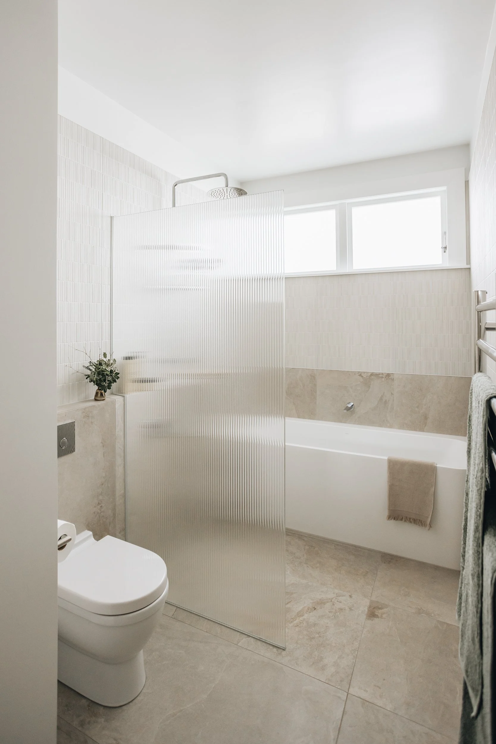 elevated-ivory-tiled-floor-half-wall-bathroom.jpg