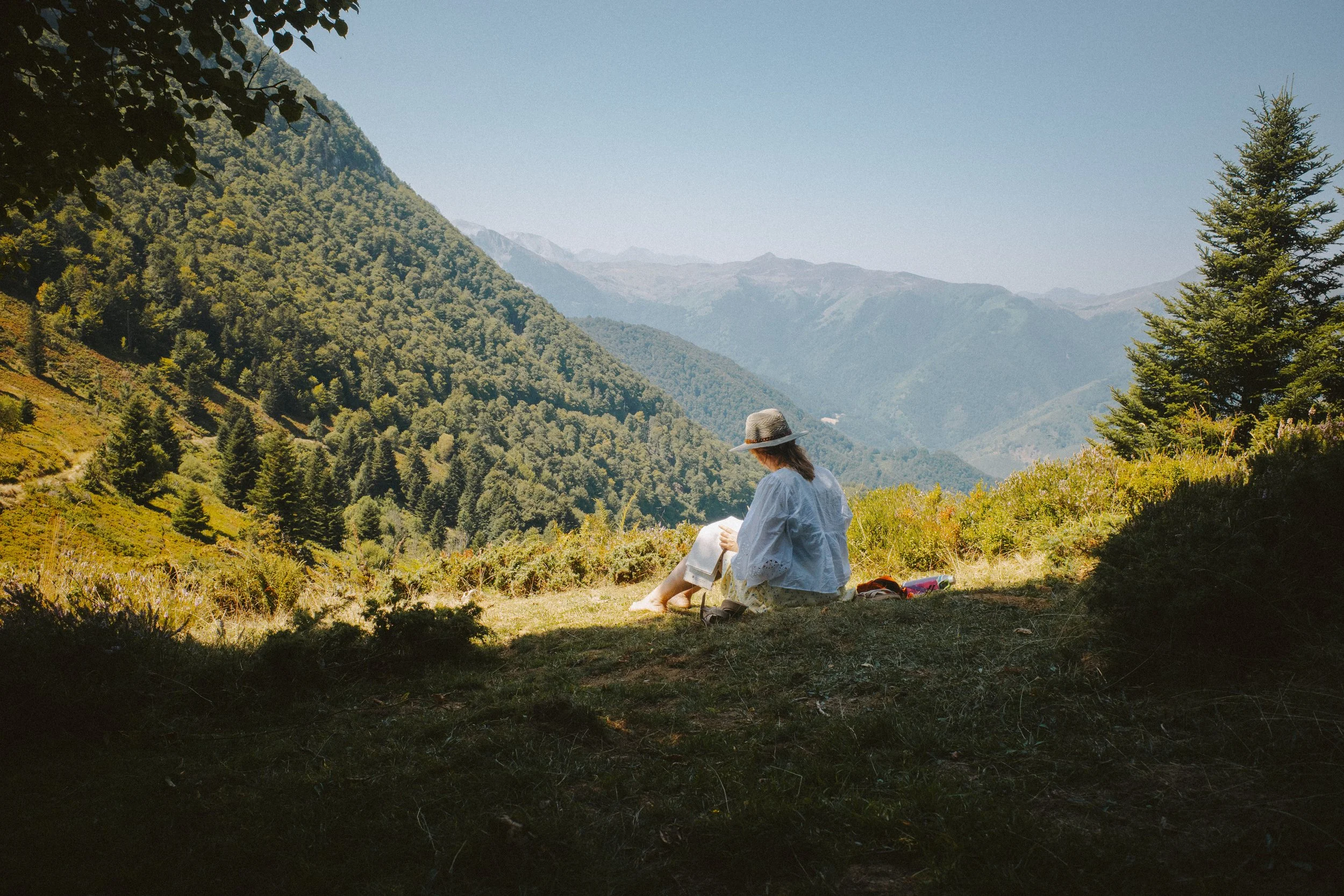 Amy Sampson Wedding Photographer sitting on the grass on a devon landscape