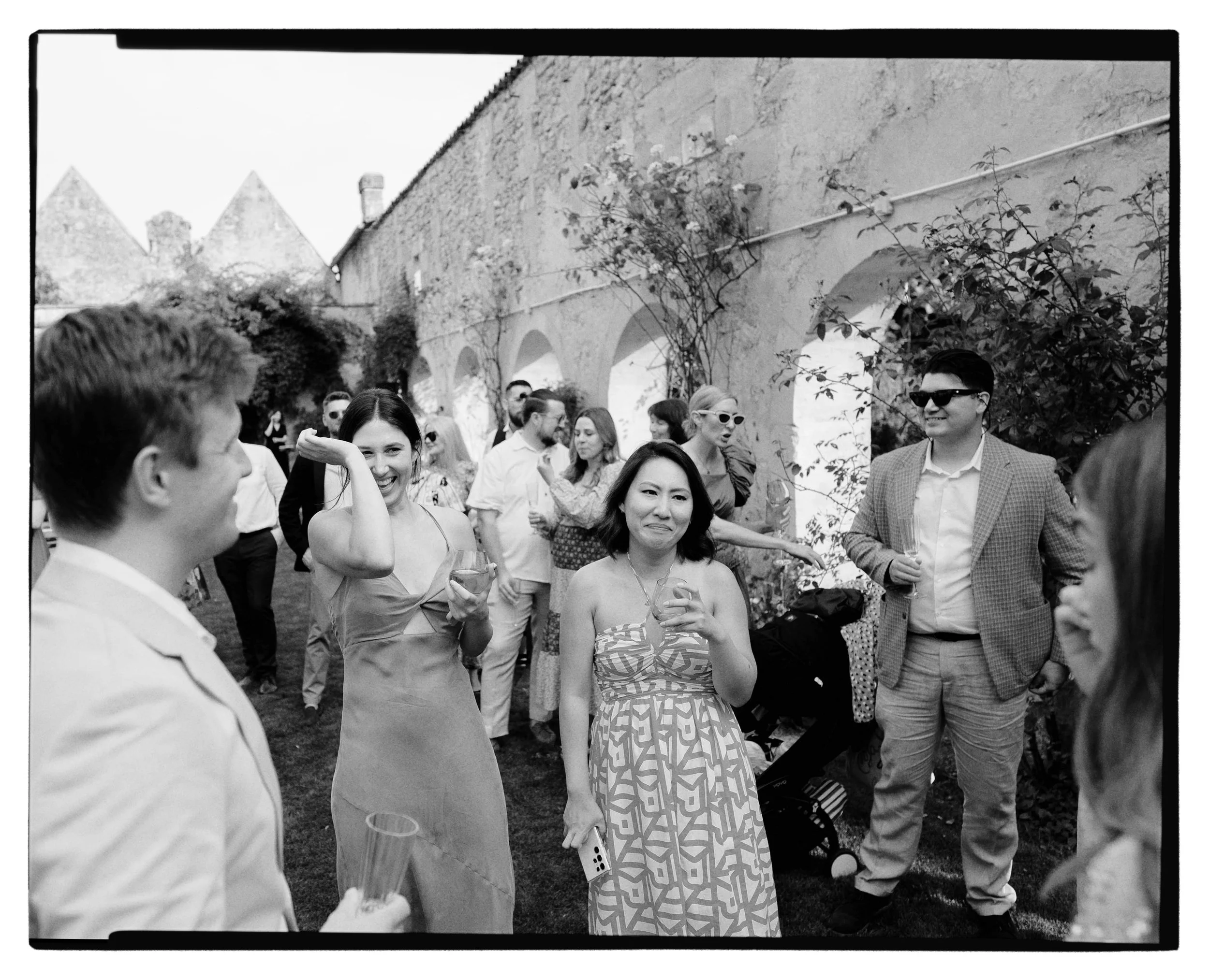Wedding reception at Chateaux in the South of France, couple chat to their guests in a rose garden