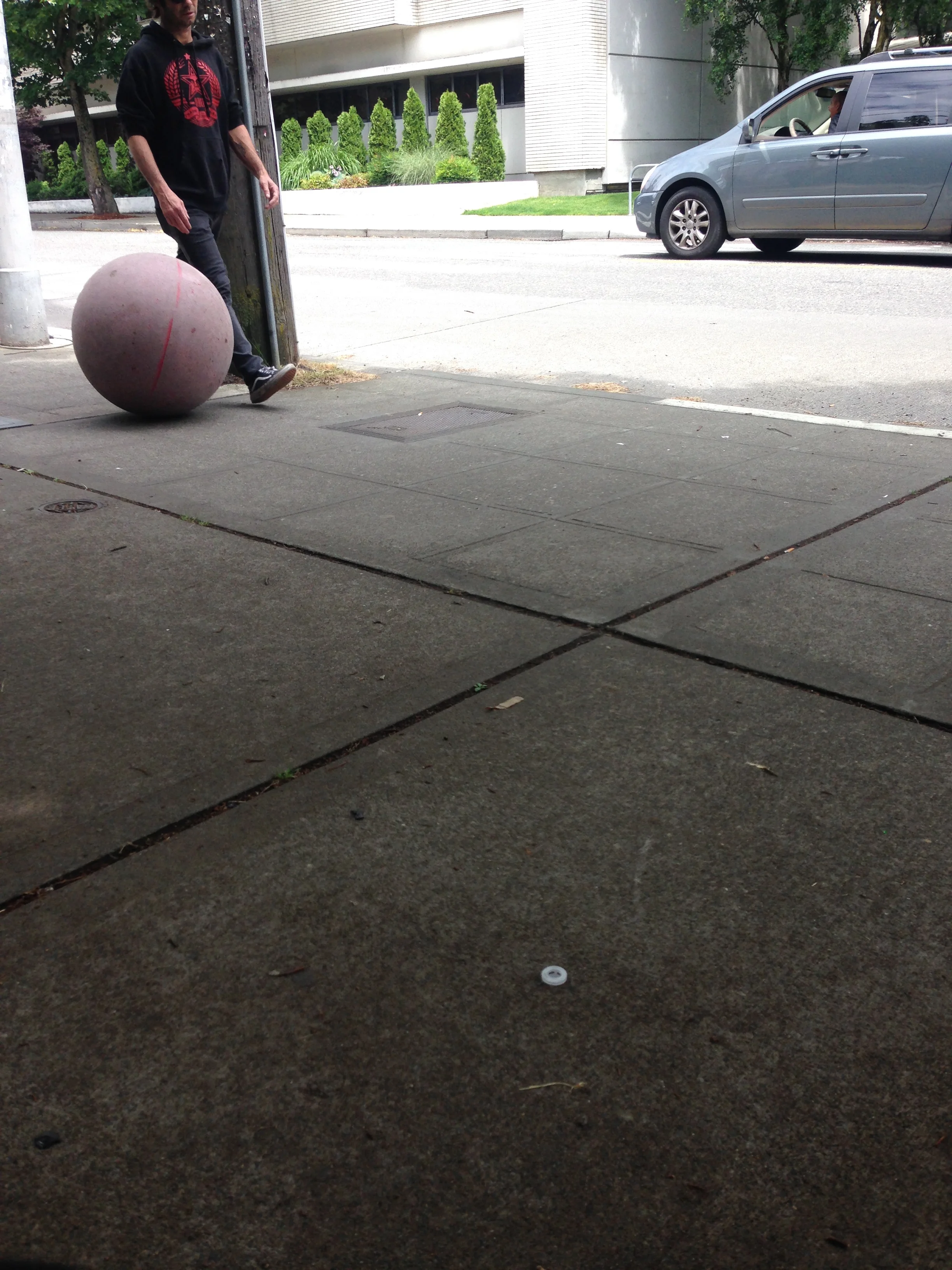 Casually walking a ball like someone would walk a dog 
