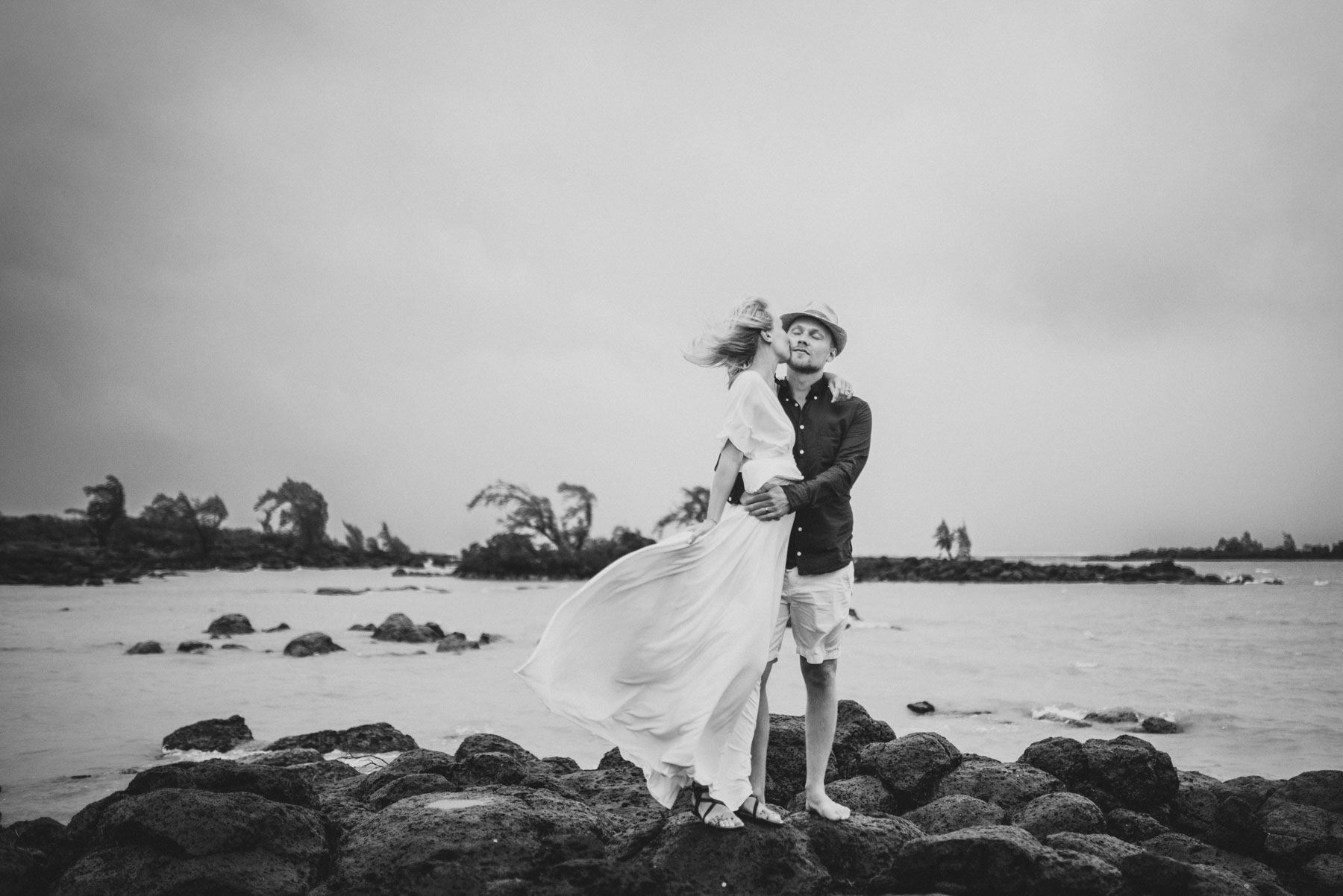 Copy of Sita Kelly | Mauritius Honeymoon Photographer | Couple standing on rocks | Couple kissing in wind in front of the sea