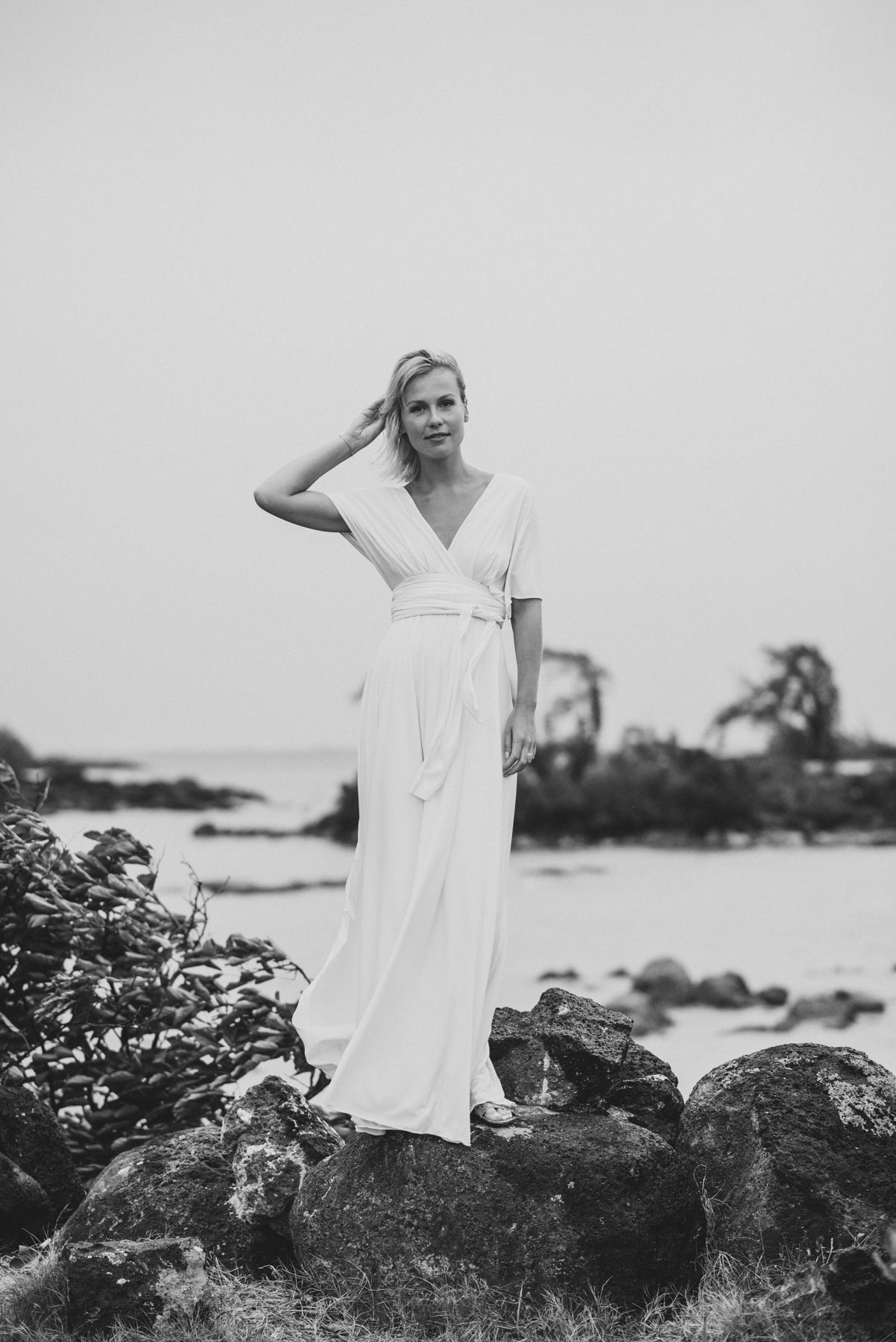 Copy of Sita Kelly | Mauritius Honeymoon Photographer | woman in a white dress standing on rocks and touching her hair
