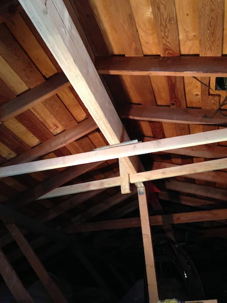 We installed temporary supports to hold the ridge beam in place while we prepared the permanent supports.