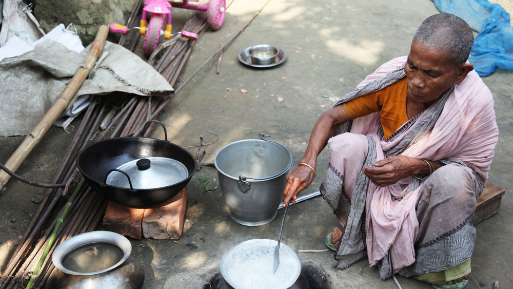 Woman cooking on an earthen stove