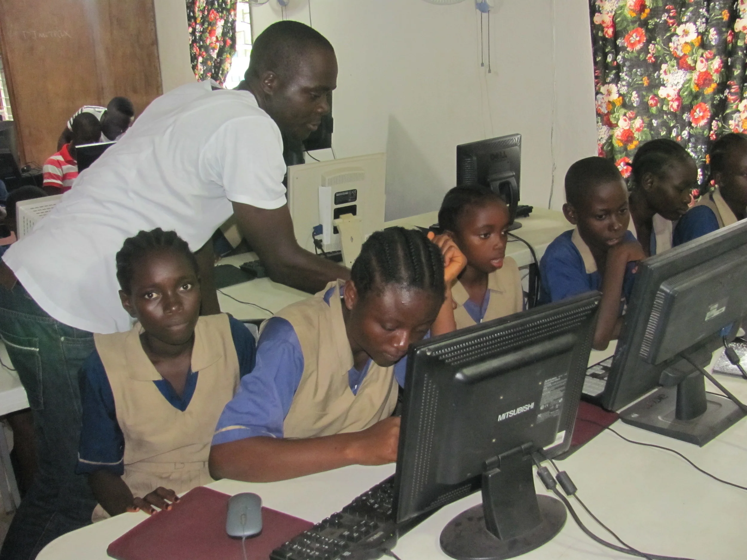 James Toe conducting computer training class for the young students at the Heart of Grace School in Monrovia