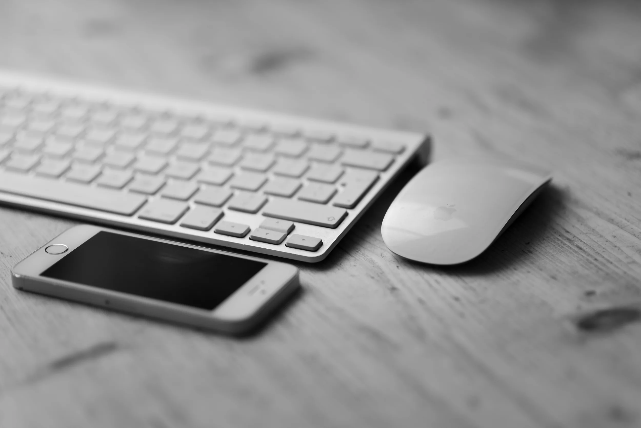 Keyboard, Mouse And Smartphone On Wooden Desk.jpg
