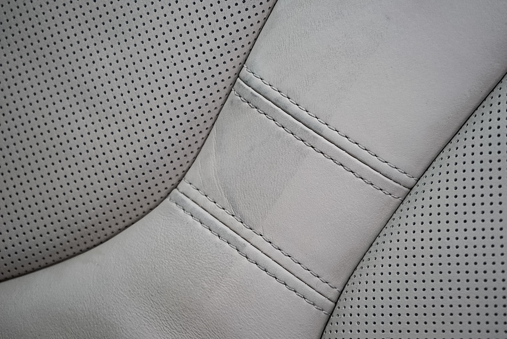 50/50 Shot of the drivers seat from a 1 Week old BMW. The left shows the dye transfer and staining after one weeks use. This car has received dealer protection and allegedly has leather guard applied. The right is after a very light clean using Leather cleaner showing the natural colour of the leather and that the dealership applied protection (Gaurd X) Is not offering protection against die transfer and soiling. Proof that dealership protection is not offering as marketed.