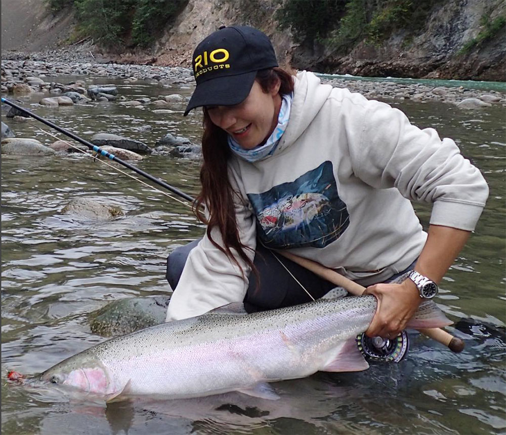 April landing a stud of a wild steelhead. Photo courtesy of the author.