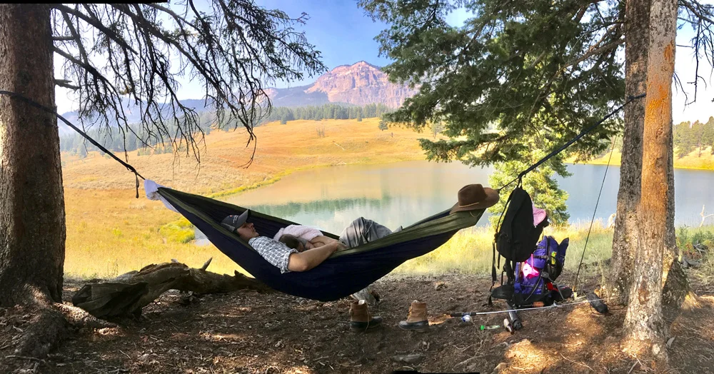 Trout Lake Siesta. The location is under a tree next to Trout Lake in Yellowstone National Park. After a nice hike up to Trout Lake with my wife and three month old daughter, it was time for a relaxing nap in the shade overlooking this beautiful view. We set up the eno, had a bite to eat and rested up before heading down to the lake to try our luck with the native Yellowstone Cutthroat Trout! The nap extended our day trip up at the Lake and was well worth the hike!